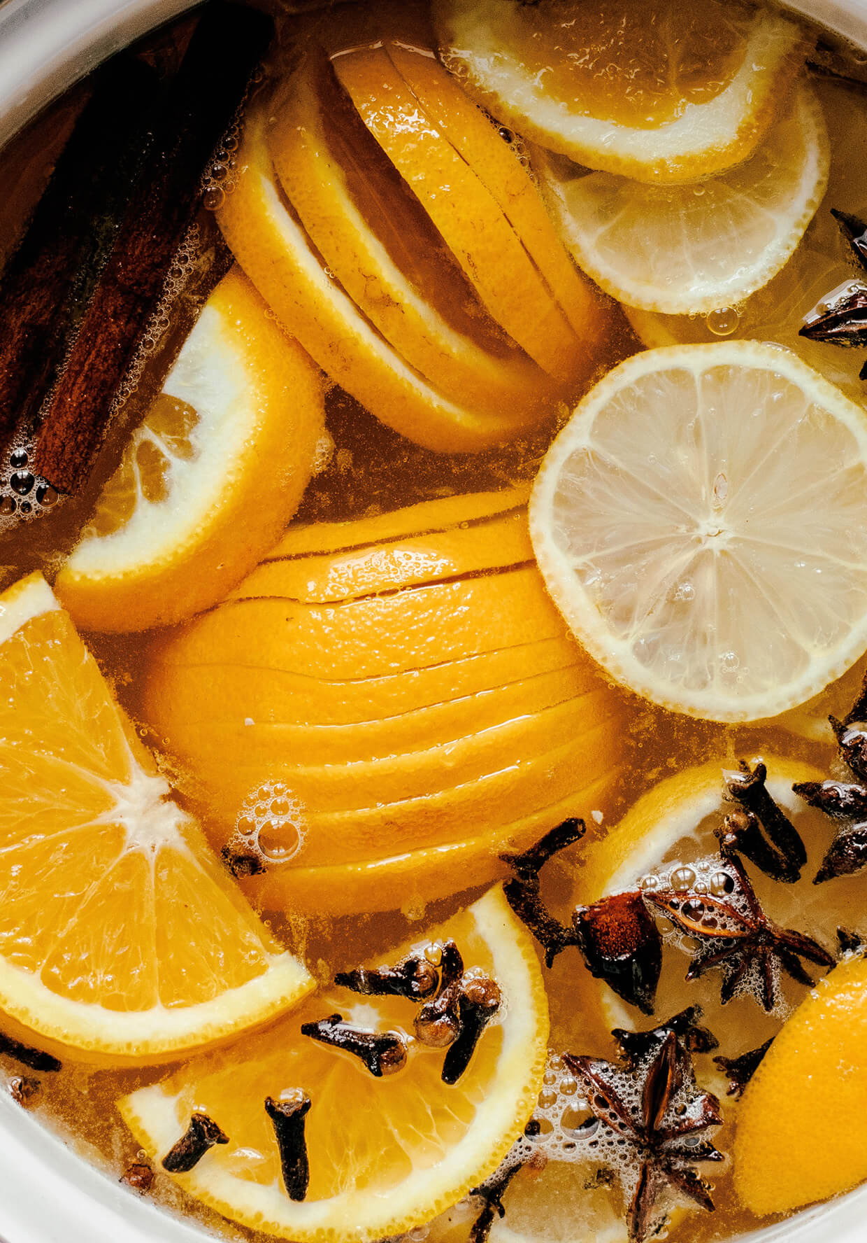 sliced oranges, lemons and spices with wine