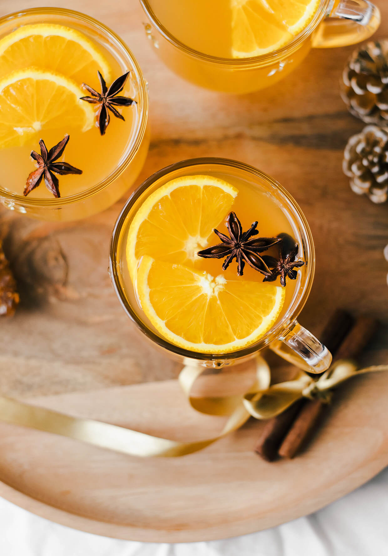 mulled wine with spiced in glasses served on wood board