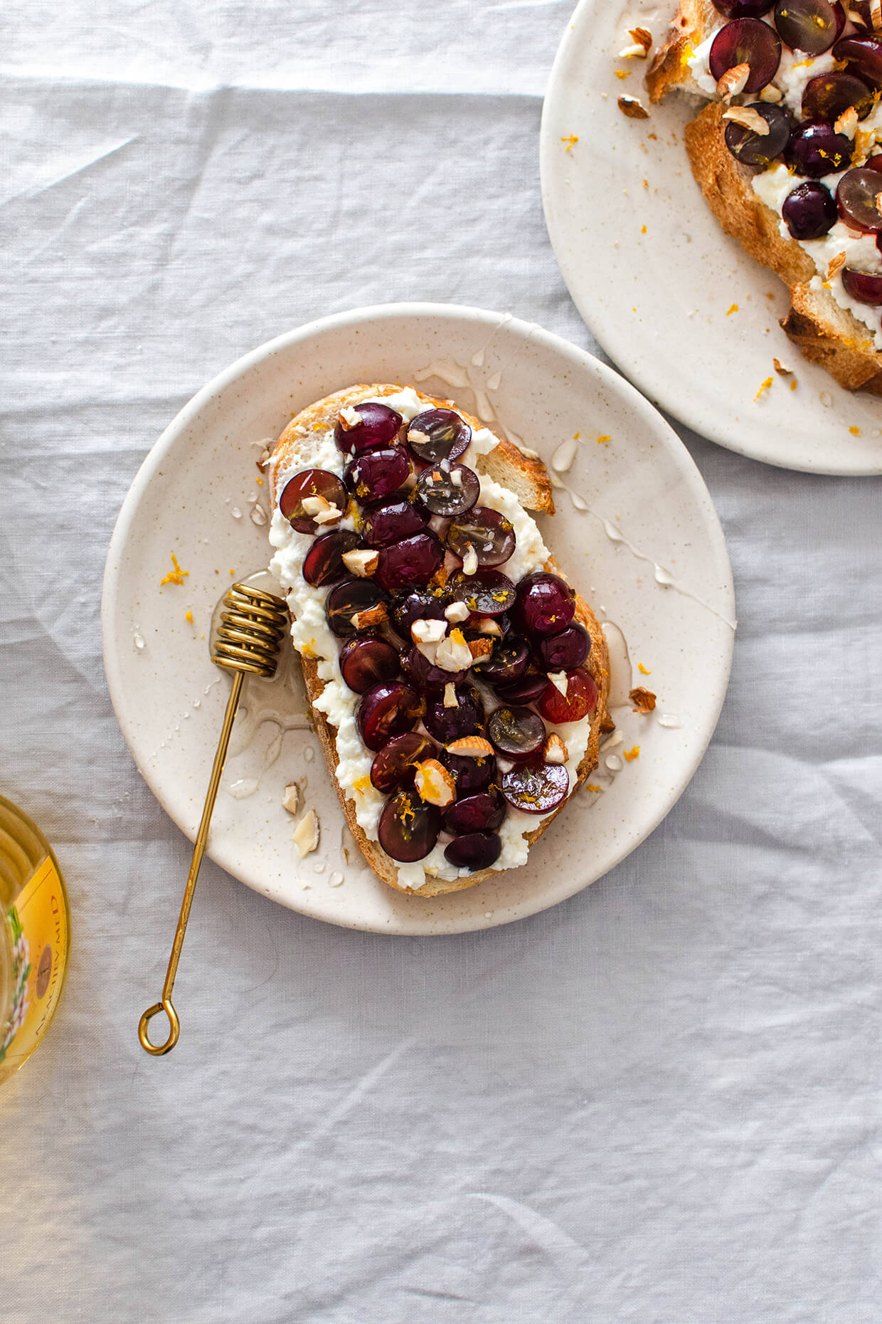 breakfast table setting with toast on plates - Recipe for Sweet cottage cheese toast with grapes, a crunchy and juicy loaded toast that makes the perfect breakfast.