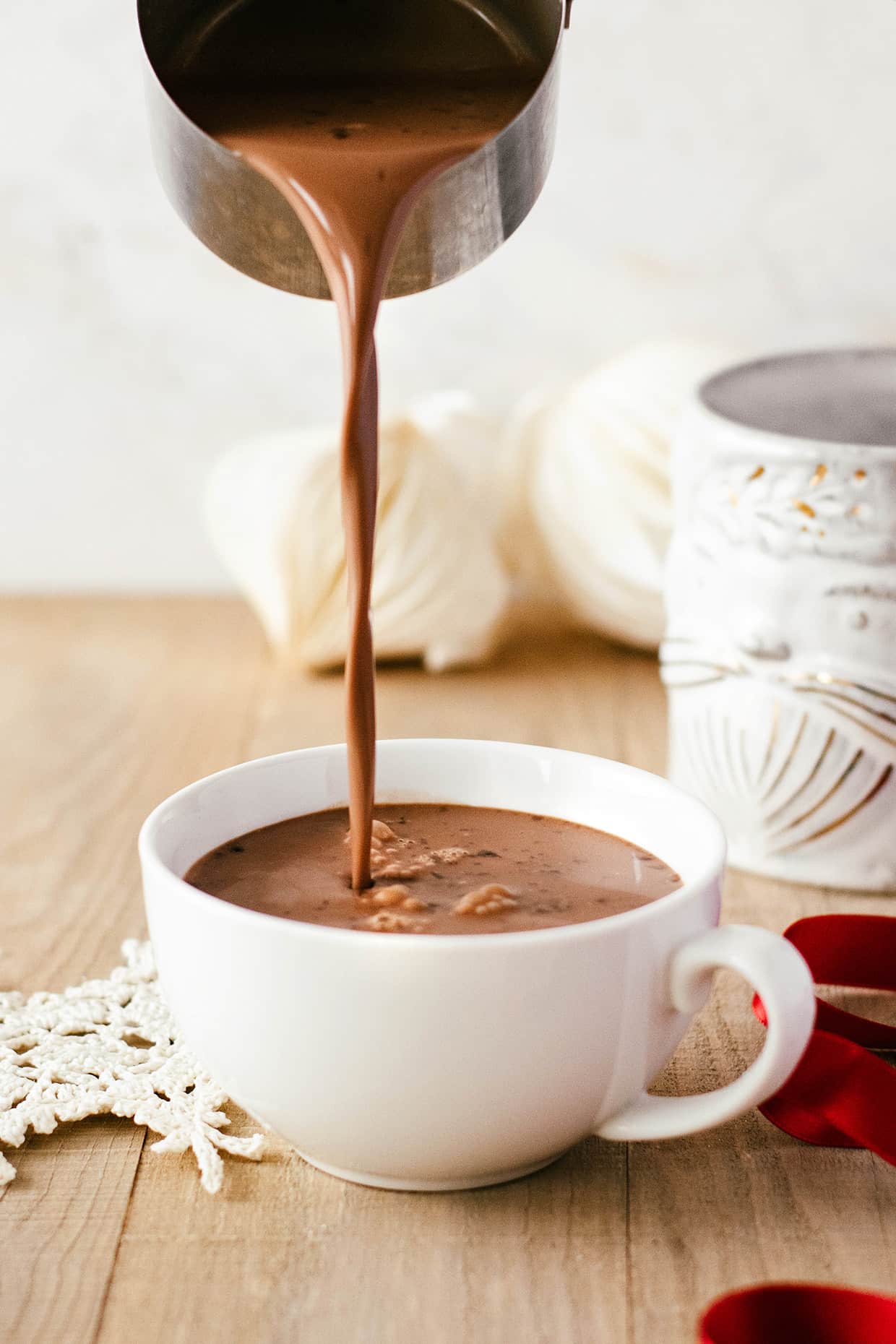 pouring hot chocolate in a mug