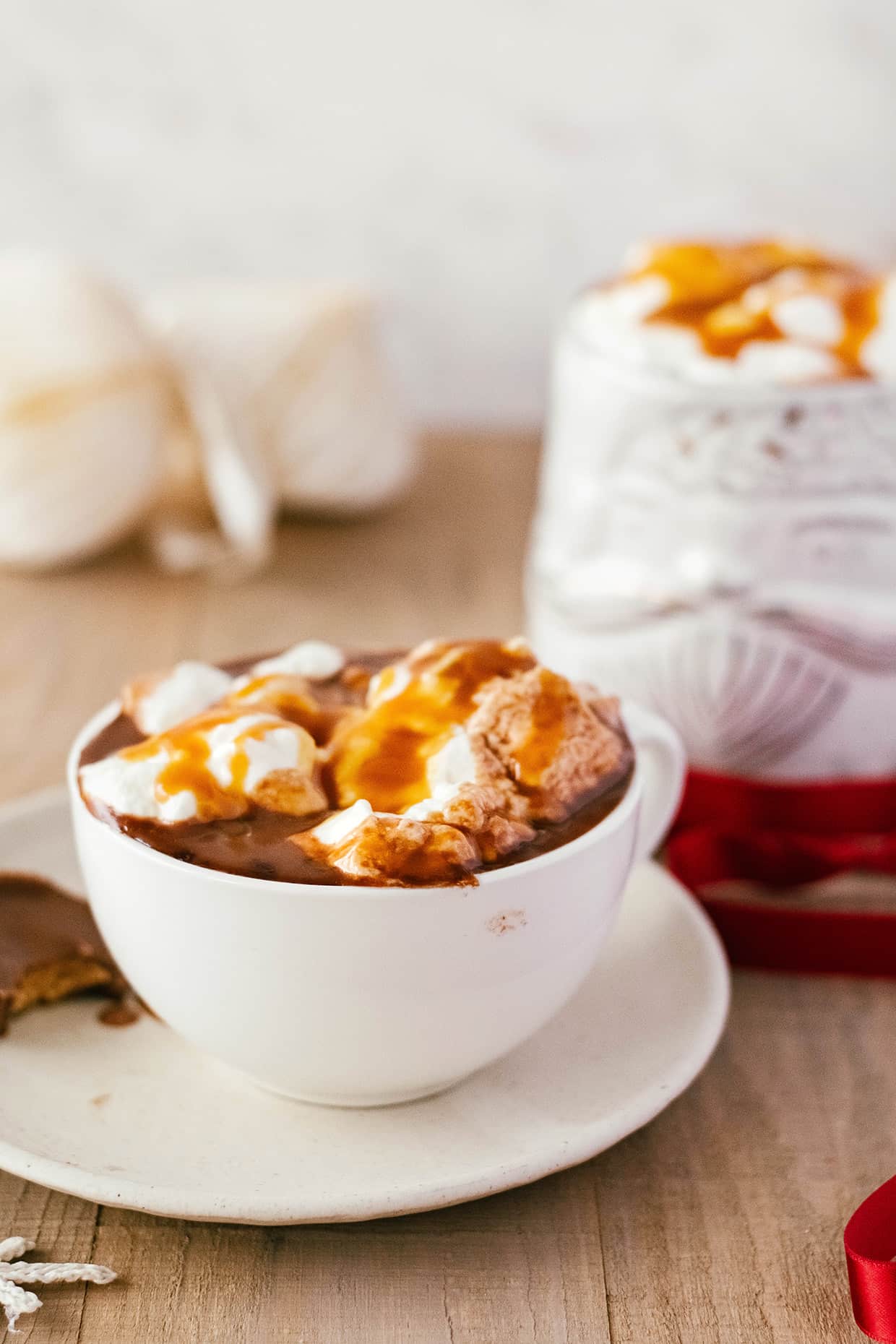 white mug with hot chocolate and whipped cream