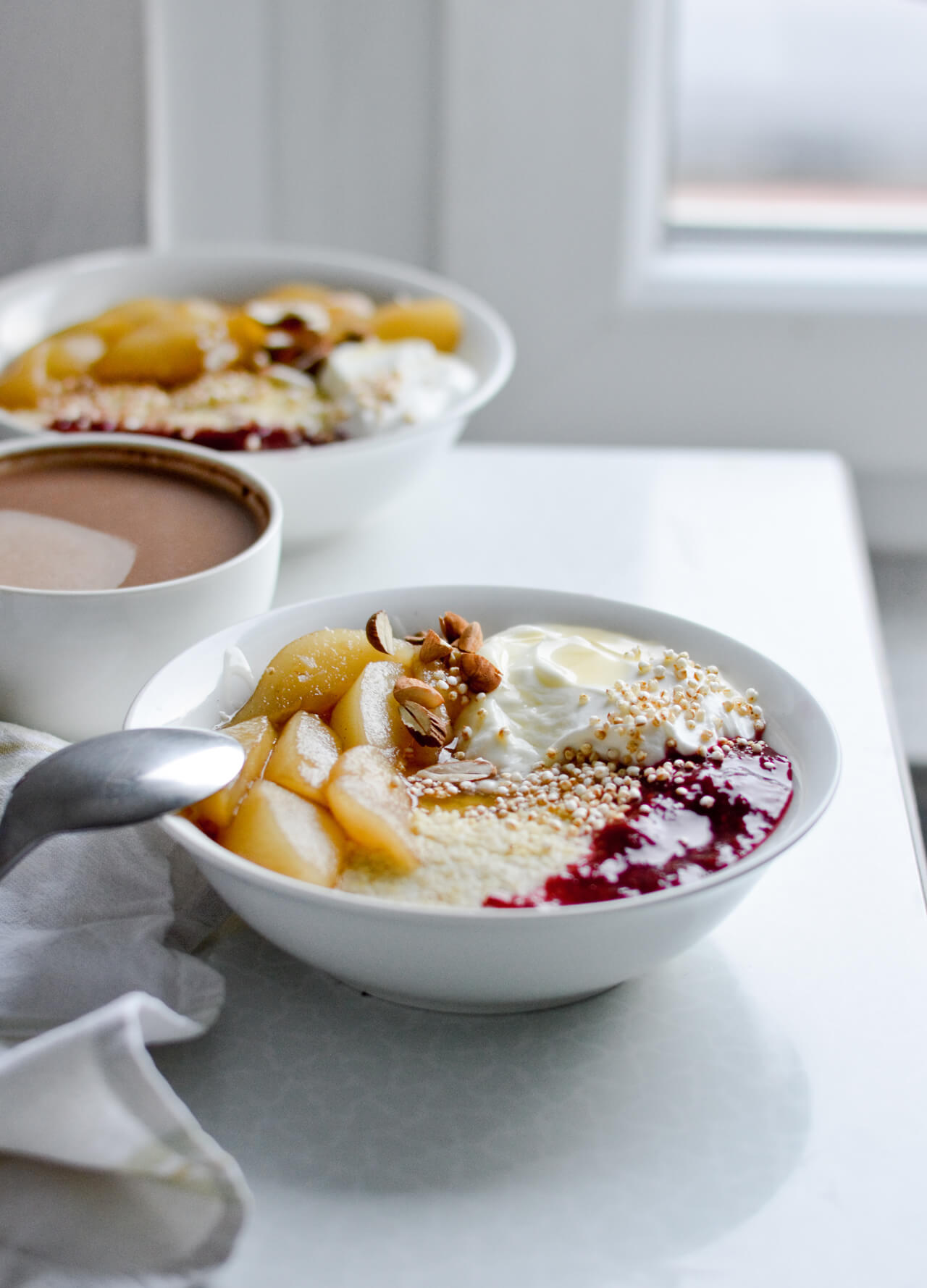 Creamy millet porridge with maple poached pears, yogurt, honey