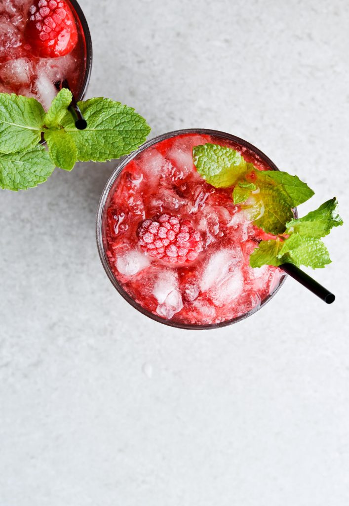glass filled with granita and raspberries