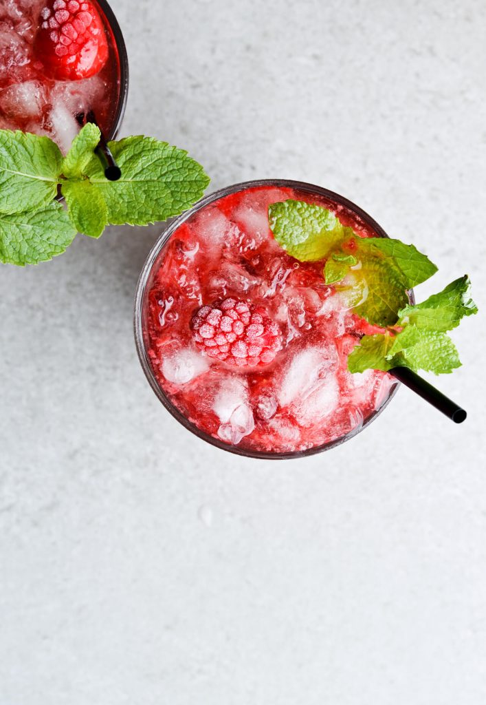 glass filled with granita and raspberries