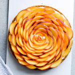 Whipped mascarpone peach tart - crumbly cookie crust filled with vanilla whipped mascarpone and topped with fresh peaches shaped like a rose! A truly impressive dessert. | sugarsalted.com