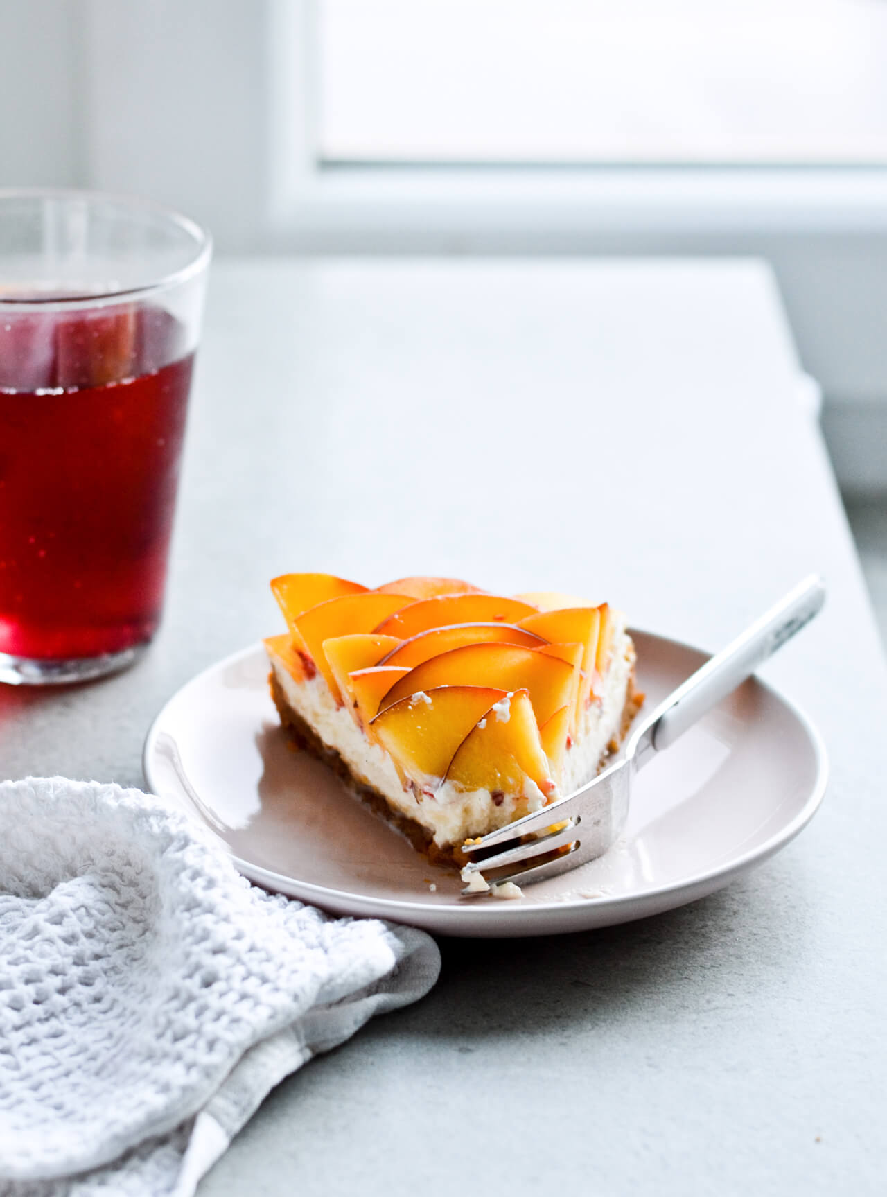 Whipped mascarpone peach tart - crumbly cookie crust filled with vanilla whipped mascarpone and topped with fresh peaches shaped like a rose! A truly impressive dessert. | sugarsalted.com