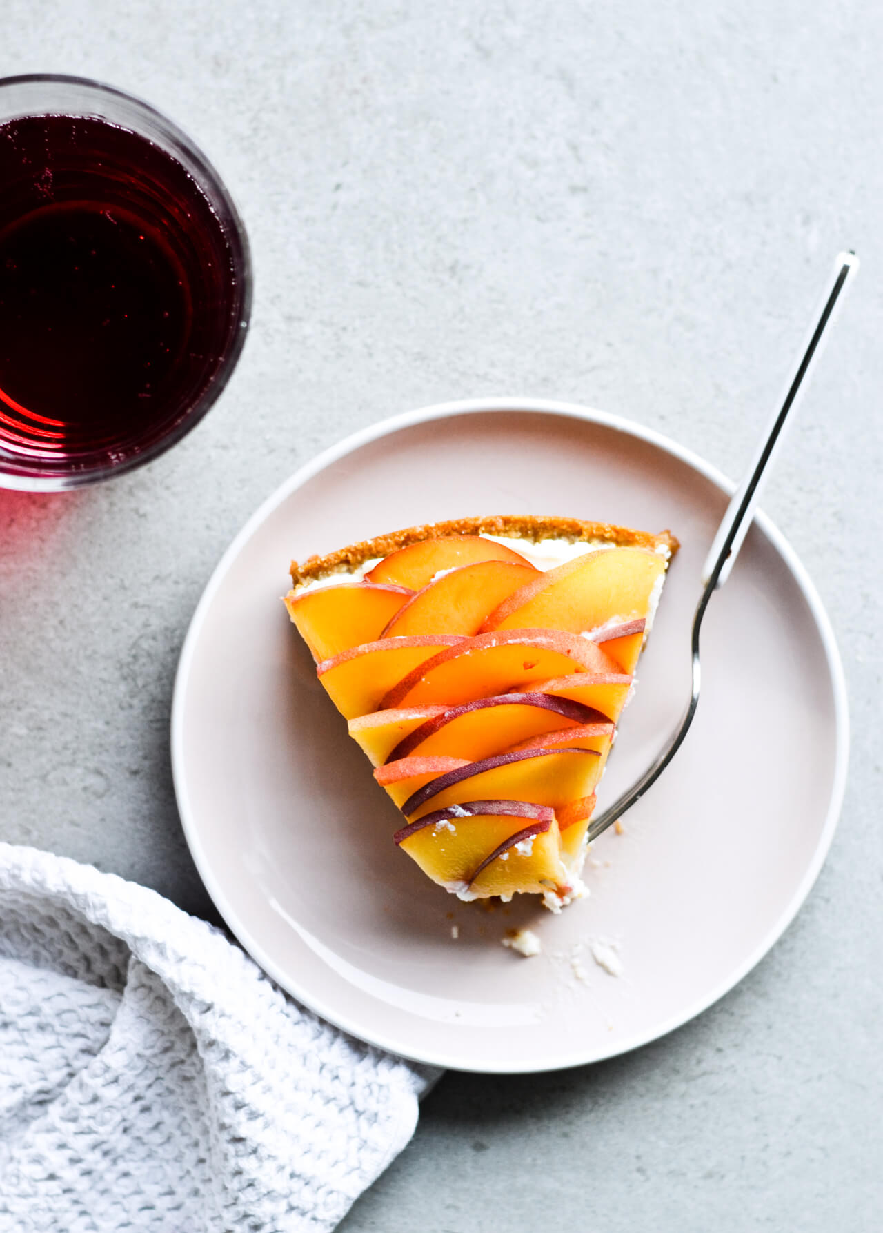 Whipped mascarpone peach tart - crumbly cookie crust filled with vanilla whipped mascarpone and topped with fresh peaches shaped like a rose! A truly impressive dessert. | sugarsalted.com