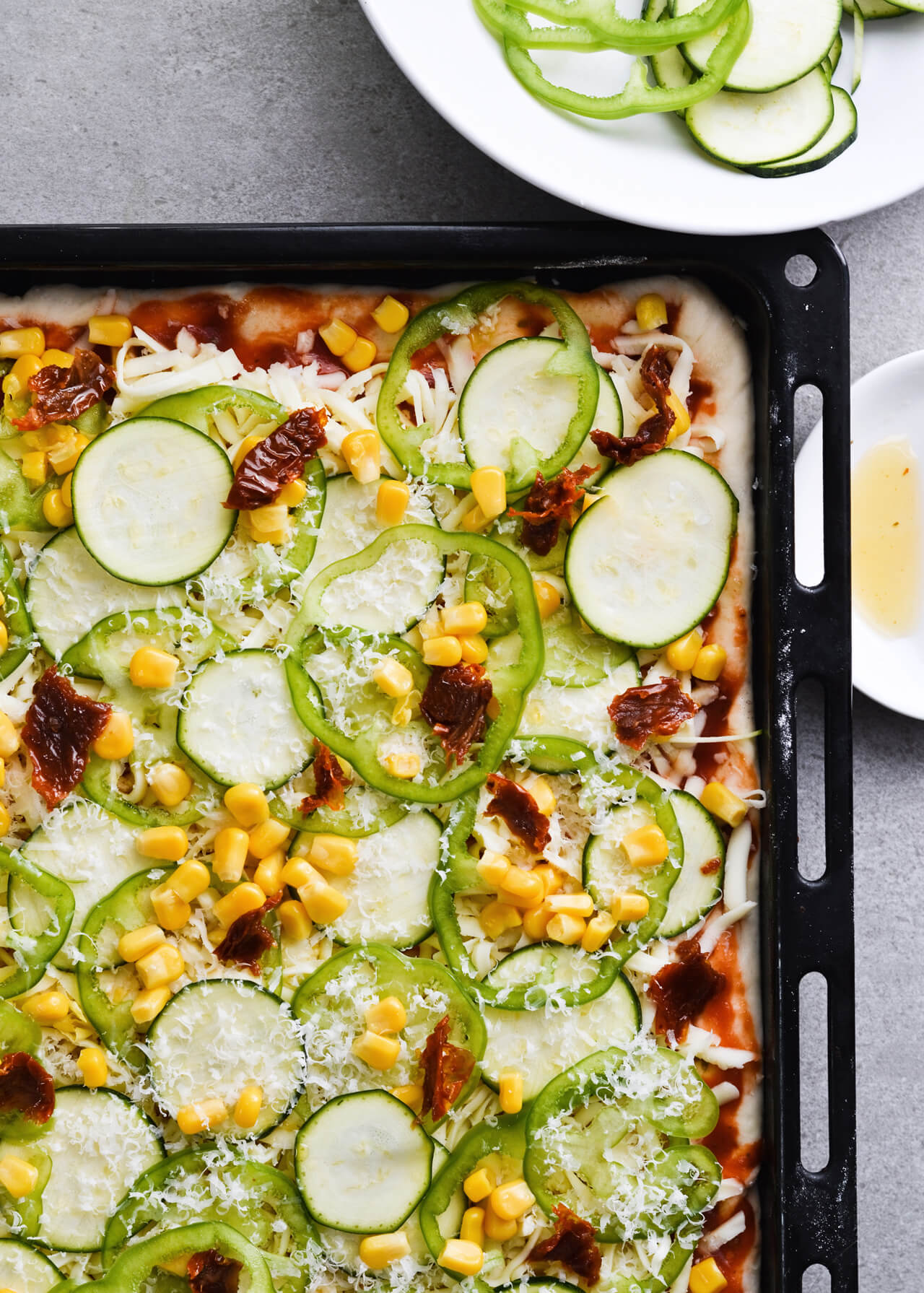 Best vegetable sheet pizza! Made with homemade pizza dough and quick pizza sauce, topped with zucchini, peppers, corn and much more! So easy to make, great for dinner and a crowd. | sugarsalted.com