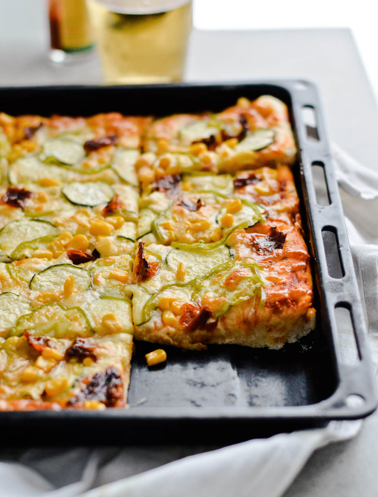 Best vegetable sheet pizza! Made with homemade pizza dough and quick pizza sauce, topped with zucchini, peppers, corn and much more! So easy to make, great for dinner and a crowd. | sugarsalted.com