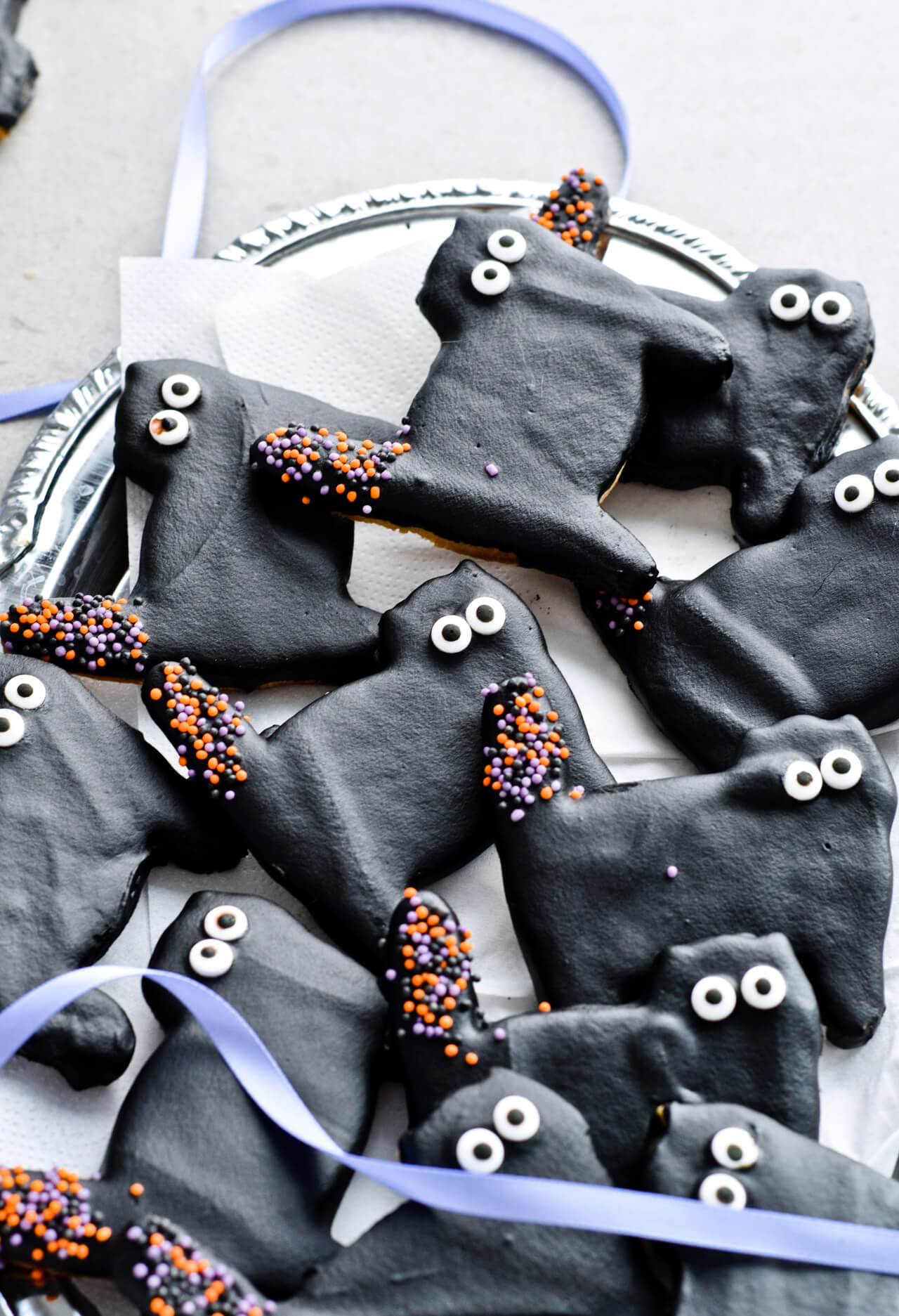 Dark chocolate cat cookies, perfect for Halloween! Or just any other fun day of the year. Sugar cookies coated with black dark chocolate and lots of sprinkles. | sugarsalted.com