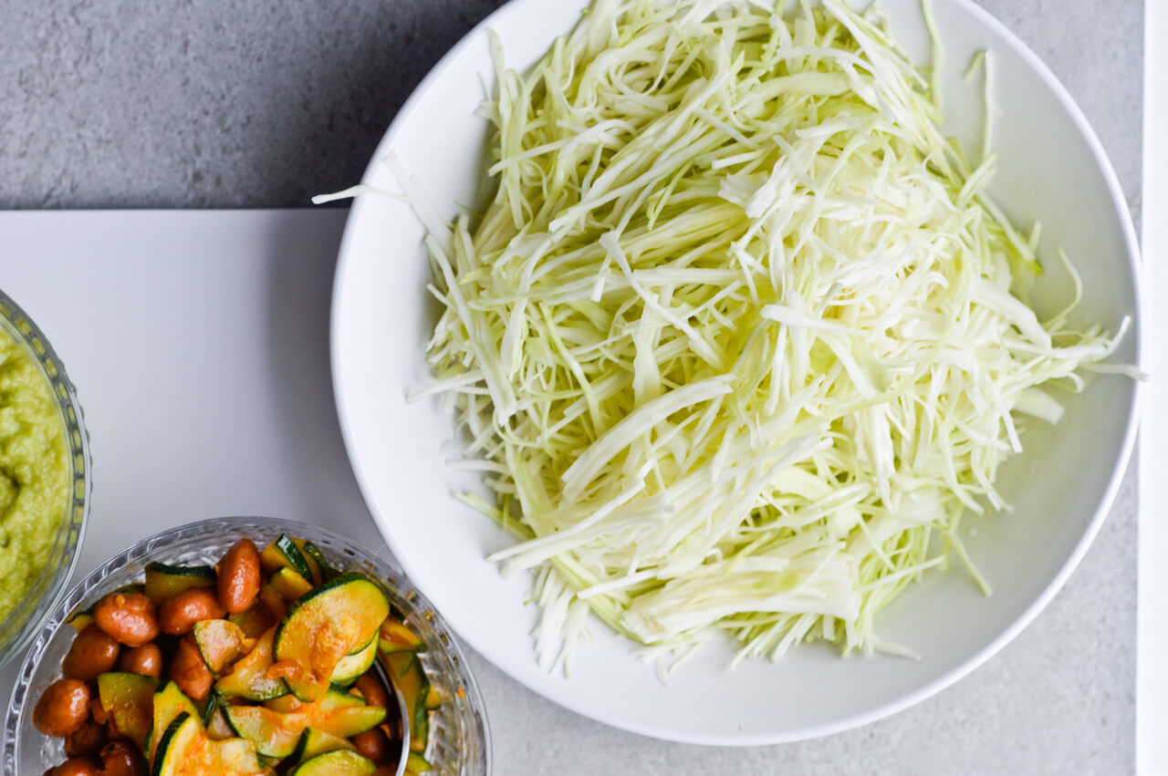 Guacamole cabbage bean tacos are the best vegetarian tacos! With easy homemade guacamole, zesty cabbage, zucchini, paprika beans and lots of cheddar! | sugarsalted.com