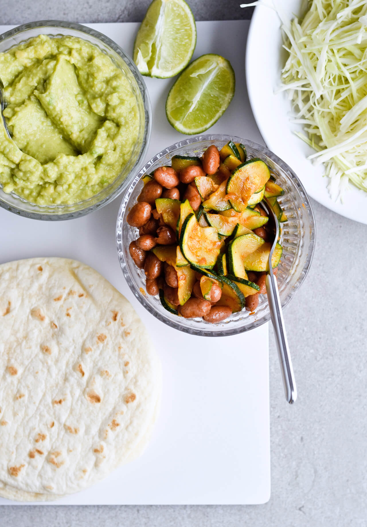 Guacamole cabbage bean tacos are the best vegetarian tacos! With easy homemade guacamole, zesty cabbage, zucchini, paprika beans and lots of cheddar! | sugarsalted.com