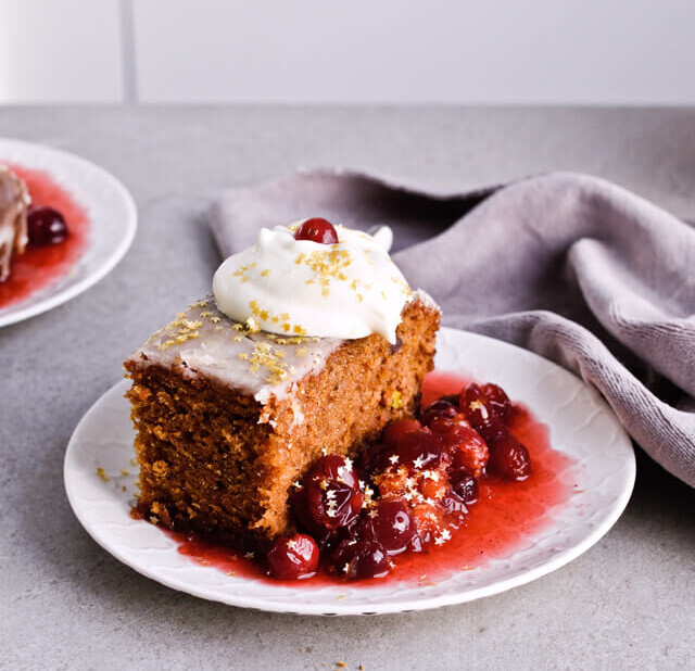 Recipe for Citrus pistachio spice cake with lemon sugar glaze, cranberry compote and homemade whipped cream. Full of cinnamon and cardamom, it almost tastes like lebkuchen. Perfect holiday treat, can be made ahead. | sugarsalted.com