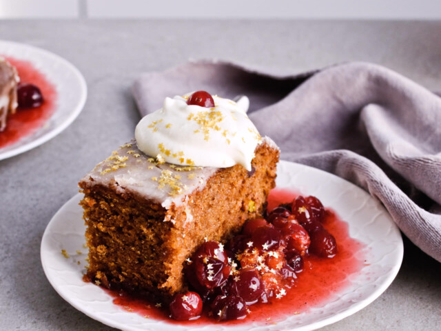 Recipe for Citrus pistachio spice cake with lemon sugar glaze, cranberry compote and homemade whipped cream. Full of cinnamon and cardamom, it almost tastes like lebkuchen. Perfect holiday treat, can be made ahead. | sugarsalted.com