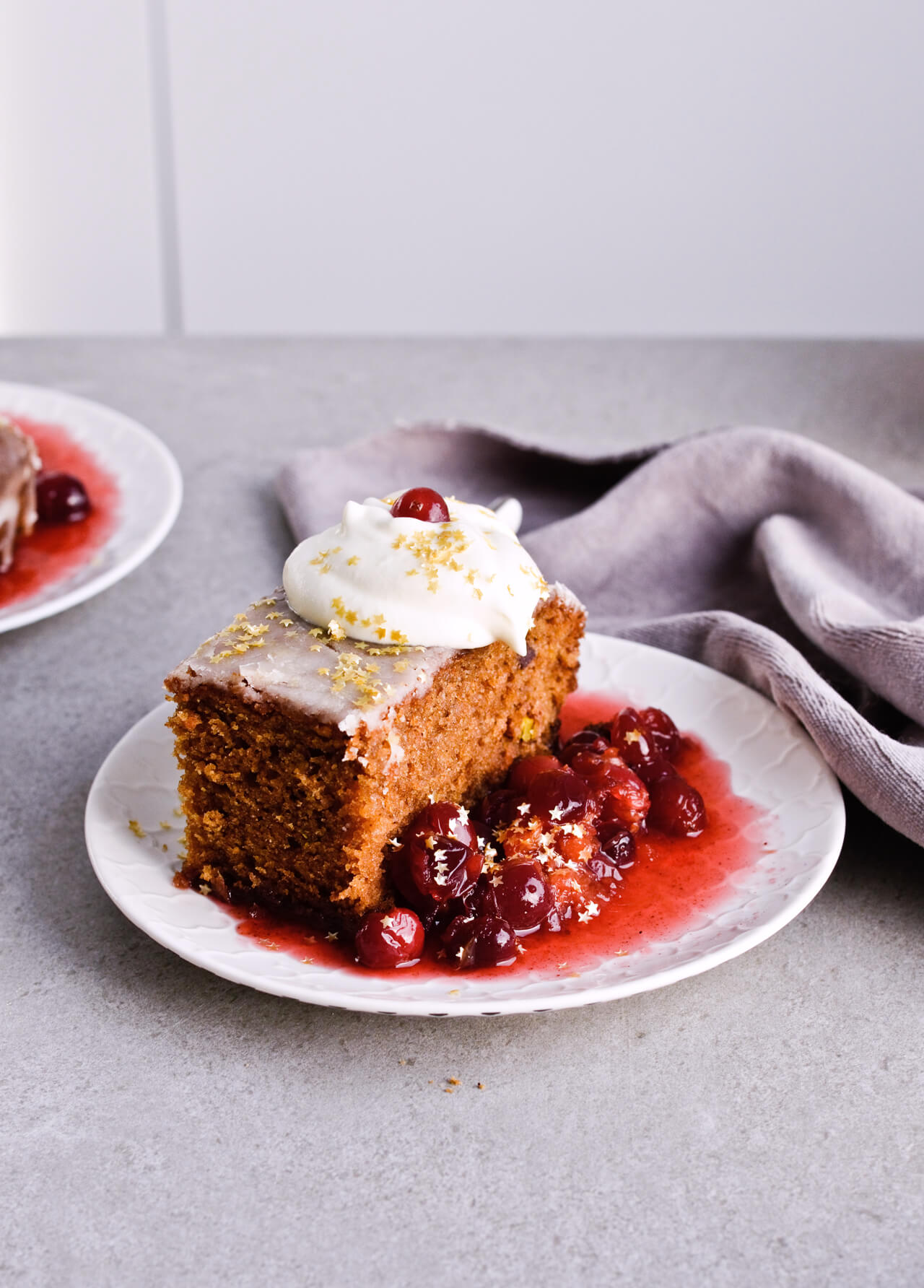 Recipe for Citrus pistachio spice cake with lemon sugar glaze, cranberry compote and homemade whipped cream. Full of cinnamon and cardamom, it almost tastes like lebkuchen. Perfect holiday treat, can be made ahead. | sugarsalted.com