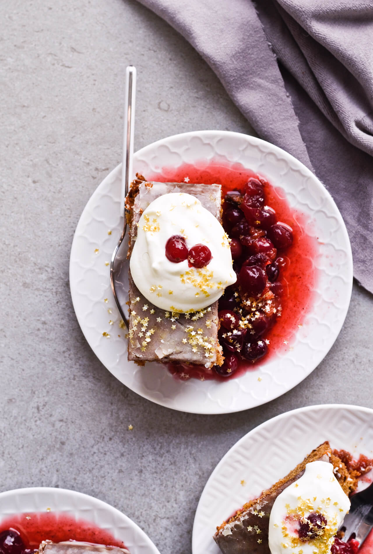 Recipe for Citrus pistachio spice cake with lemon sugar glaze, cranberry compote and homemade whipped cream. Full of cinnamon and cardamom, it almost tastes like lebkuchen. Perfect holiday treat, can be made ahead. | sugarsalted.com