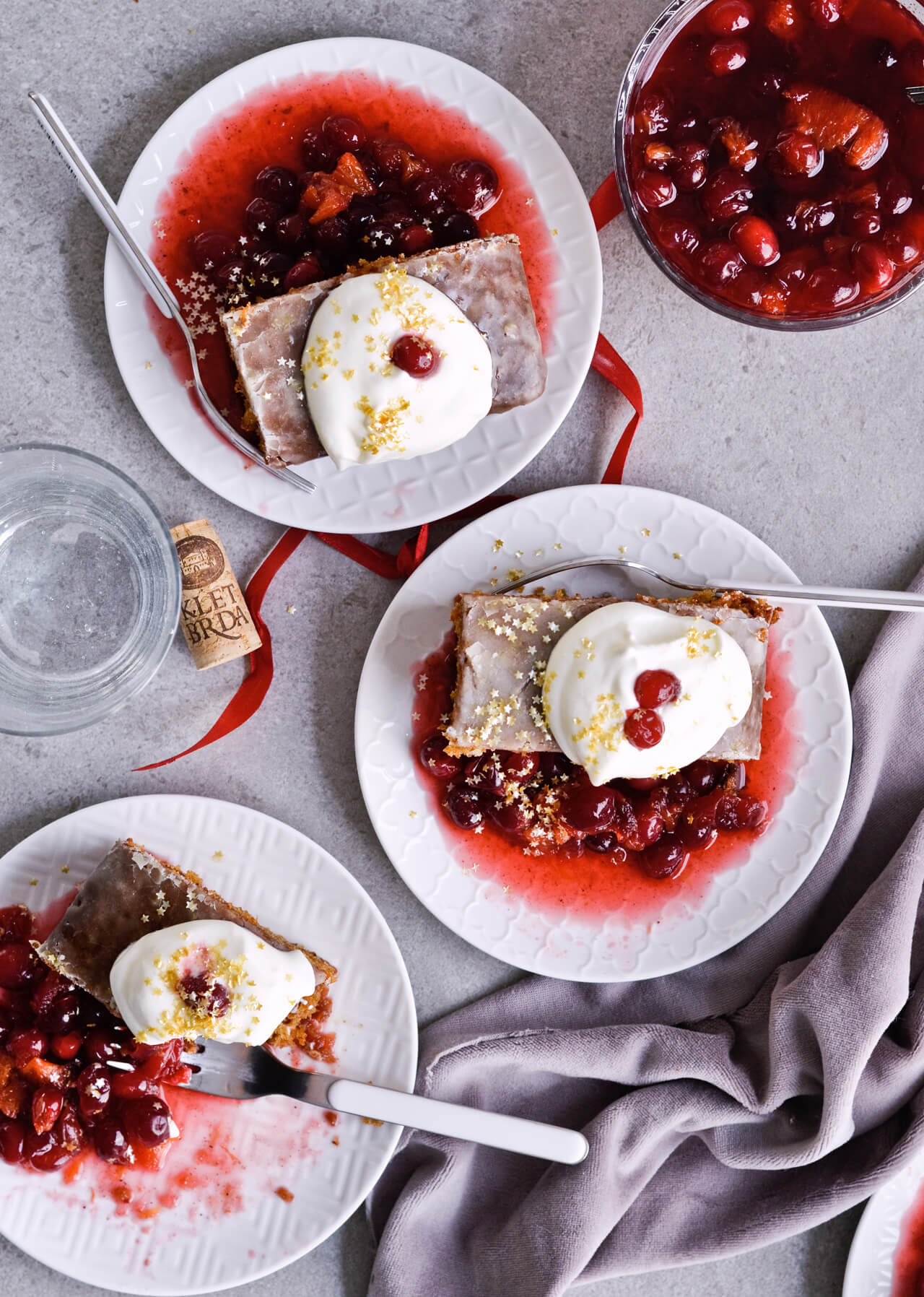 Recipe for Citrus pistachio spice cake with lemon sugar glaze, cranberry compote and homemade whipped cream. Full of cinnamon and cardamom, it almost tastes like lebkuchen. Perfect holiday treat, can be made ahead. | sugarsalted.com