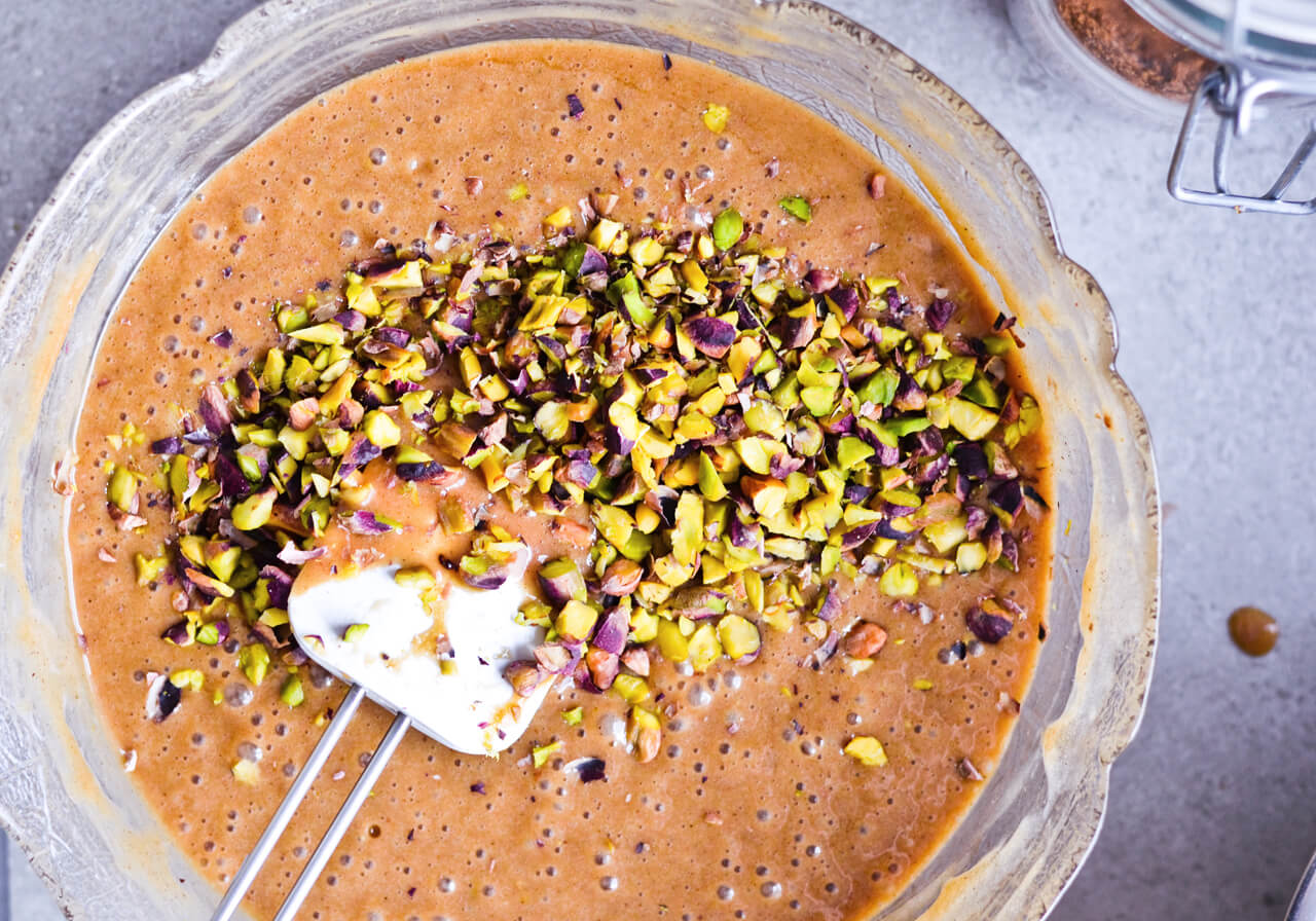 Recipe for Citrus pistachio spice cake with lemon sugar glaze, cranberry compote and homemade whipped cream. Full of cinnamon and cardamom, it almost tastes like lebkuchen. Perfect holiday treat, can be made ahead. | sugarsalted.com