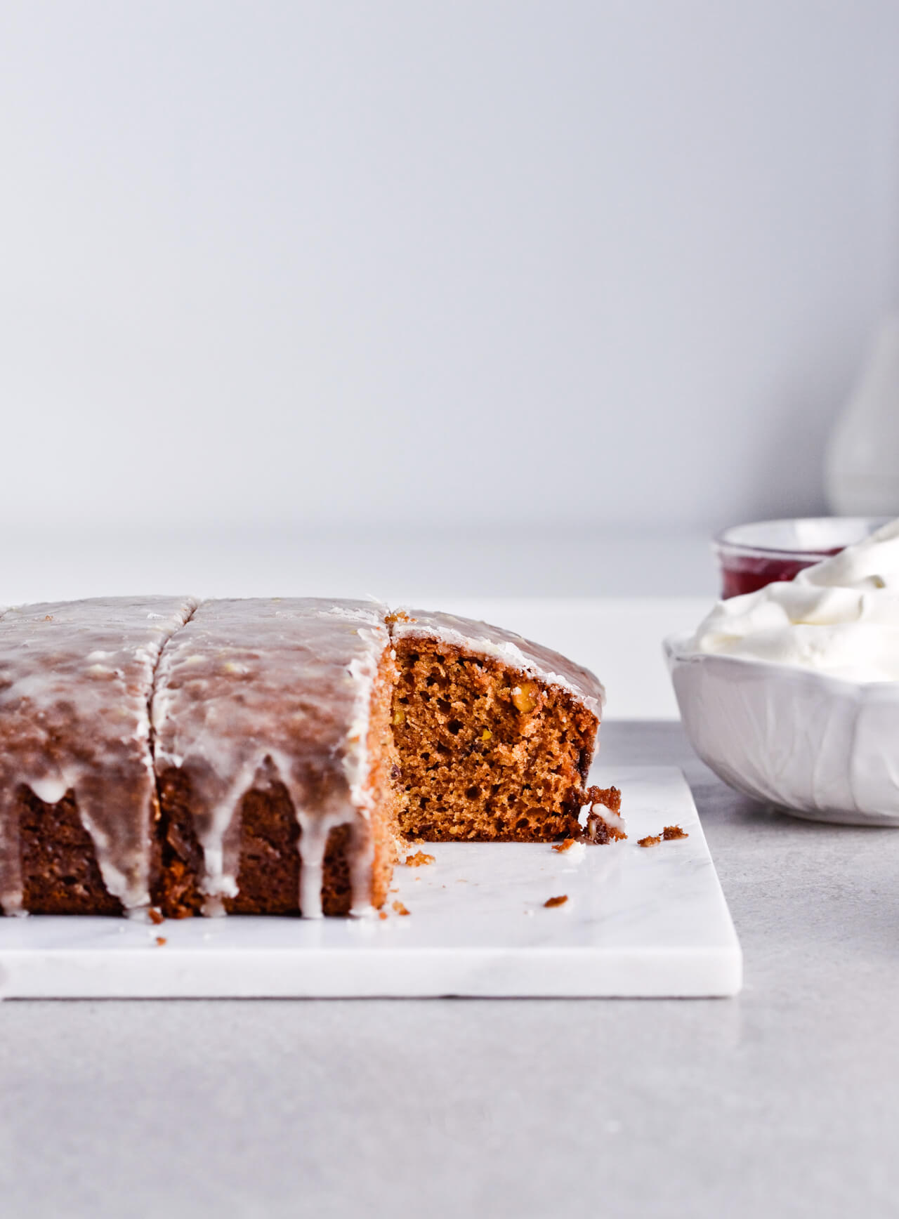 Recipe for Citrus pistachio spice cake with lemon sugar glaze, cranberry compote and homemade whipped cream. Full of cinnamon and cardamom, it almost tastes like lebkuchen. Perfect holiday treat, can be made ahead. | sugarsalted.com