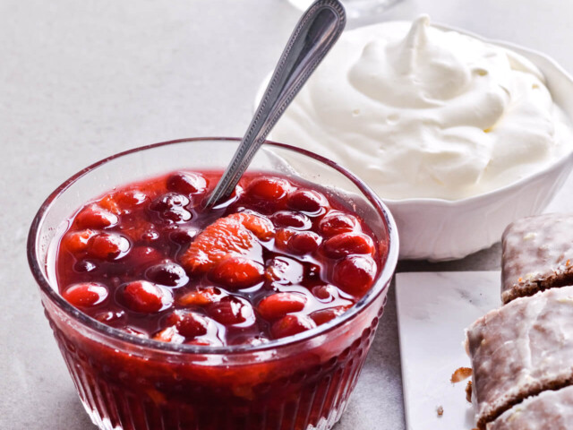 Orange cranberry compote with maple syrup for Citrus pistachio spice cake with lemon sugar glaze and homemade whipped cream. Full of cinnamon and cardamom, it almost tastes like lebkuchen. Perfect holiday treat, can be made ahead. | sugarsalted.com