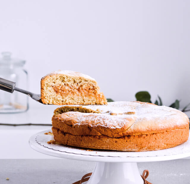 Recipe for Slovenian apple pie, which is almost a torte. Made with a sour cream, crumbly and cookie-like crust, topped with grated apples which make a very juicy filling. Easily sliced into pieces and perfect for serving to a group or potluck parties. Very easy to make. | sugarsalted.com