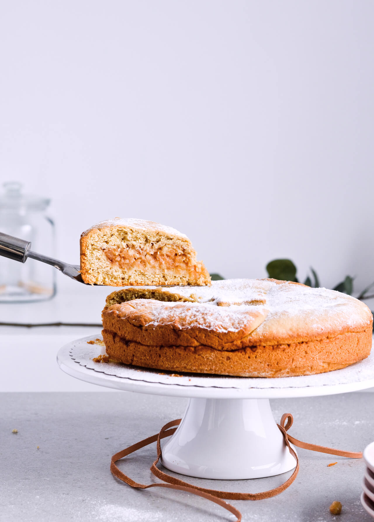 Recipe for Slovenian apple pie, which is almost a torte. Made with a sour cream, crumbly and cookie-like crust, topped with grated apples which make a very juicy filling. Easily sliced into pieces and perfect for serving to a group or potluck parties. Very easy to make. | sugarsalted.com