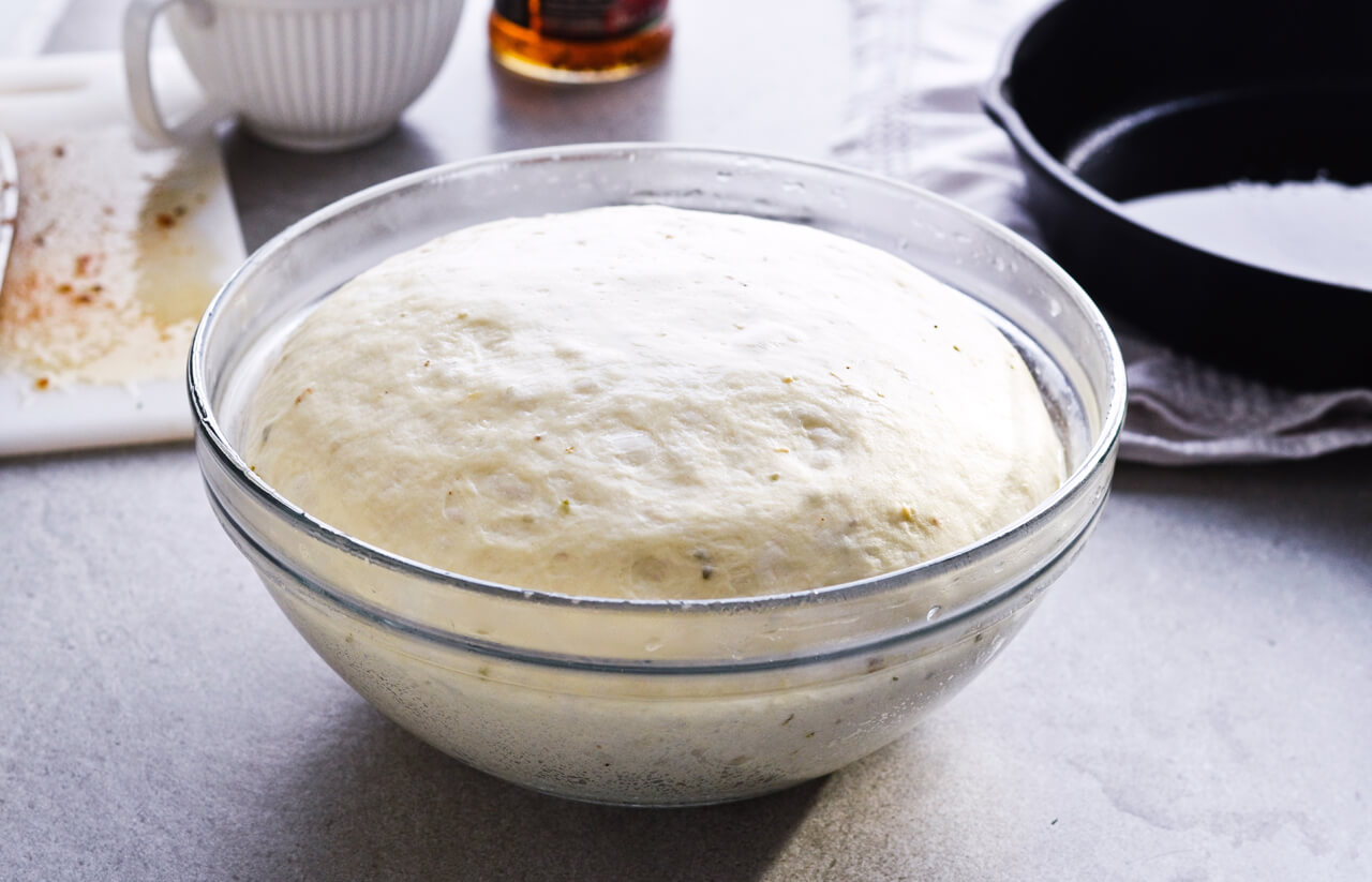 Recipe for sun-dried tomato herb skillet rolls. Dough infused with oregano and rolls drenched with parsley butter and sun-dried tomatoes. Soft, individual rolls straight from the skillet, great for the holiday dinner table. | sugarsalted.com