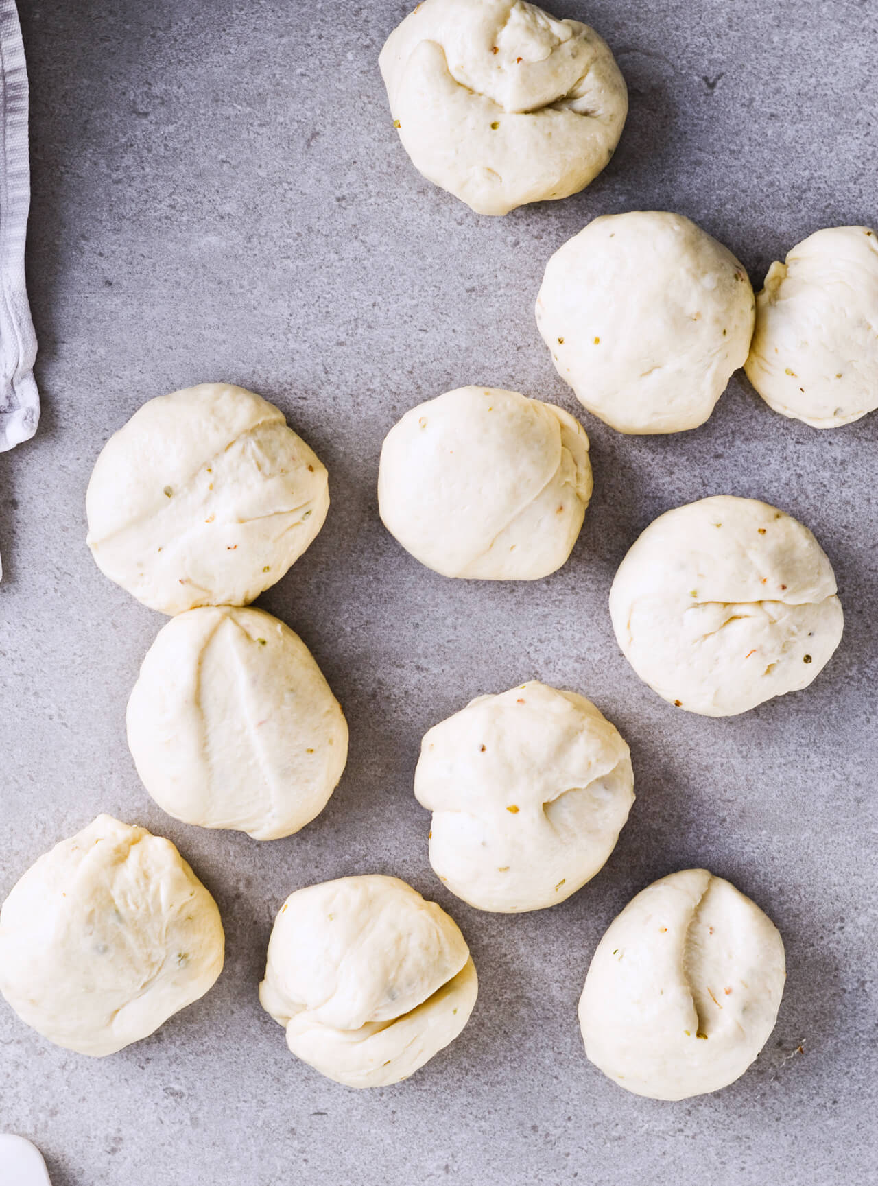 Recipe for sun-dried tomato herb skillet rolls. Dough infused with oregano and rolls drenched with parsley butter and sun-dried tomatoes. Soft, individual rolls straight from the skillet, great for the holiday dinner table. | sugarsalted.com