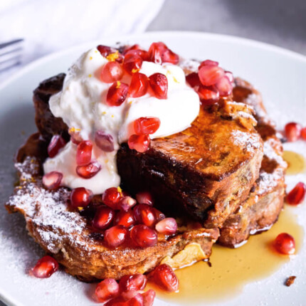 Recipe for Orange yogurt Stollen french toast. Christmas Stollen prepared as classic french toast, topped with creamy orange Greek yogurt, pomegranate seeds, maple syrup. Perfect breakfast or brunch recipe. | @mitzyathome sugarsalted.com