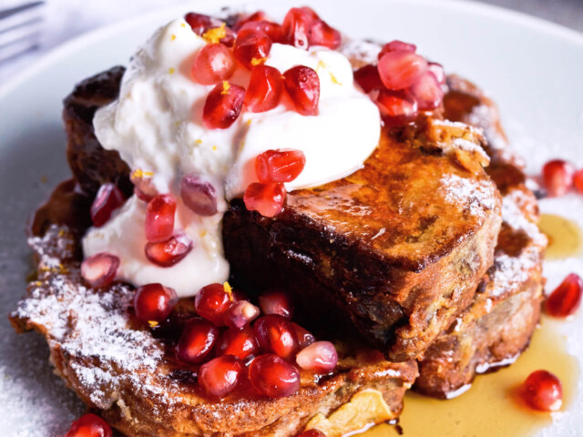 Recipe for Orange yogurt Stollen french toast. Christmas Stollen prepared as classic french toast, topped with creamy orange Greek yogurt, pomegranate seeds, maple syrup. Perfect breakfast or brunch recipe. | @mitzyathome sugarsalted.com