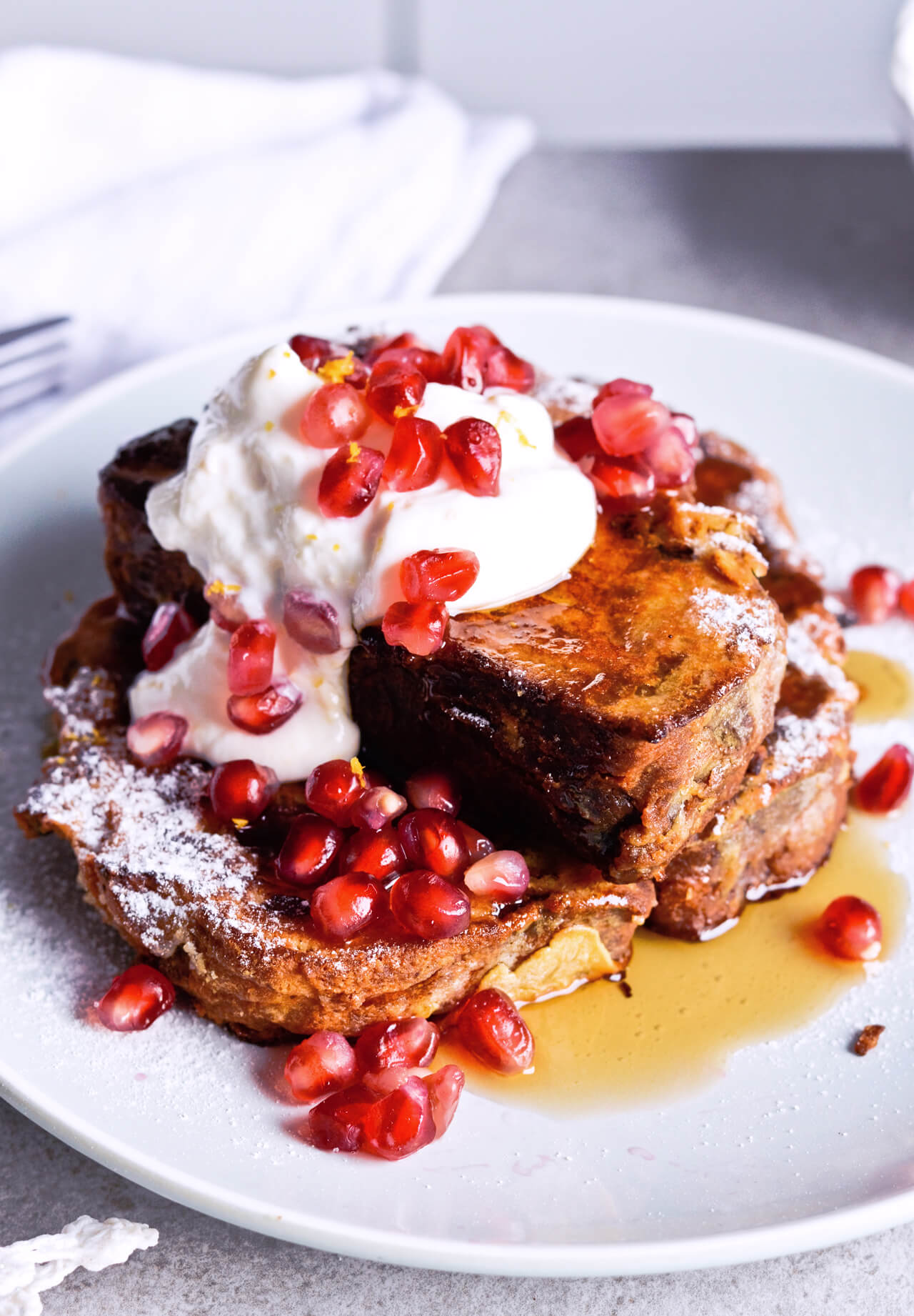 Recipe for Orange yogurt Stollen french toast. Christmas Stollen prepared as classic french toast, topped with creamy orange Greek yogurt, pomegranate seeds, maple syrup. Perfect breakfast or brunch recipe. | @mitzyathome sugarsalted.com