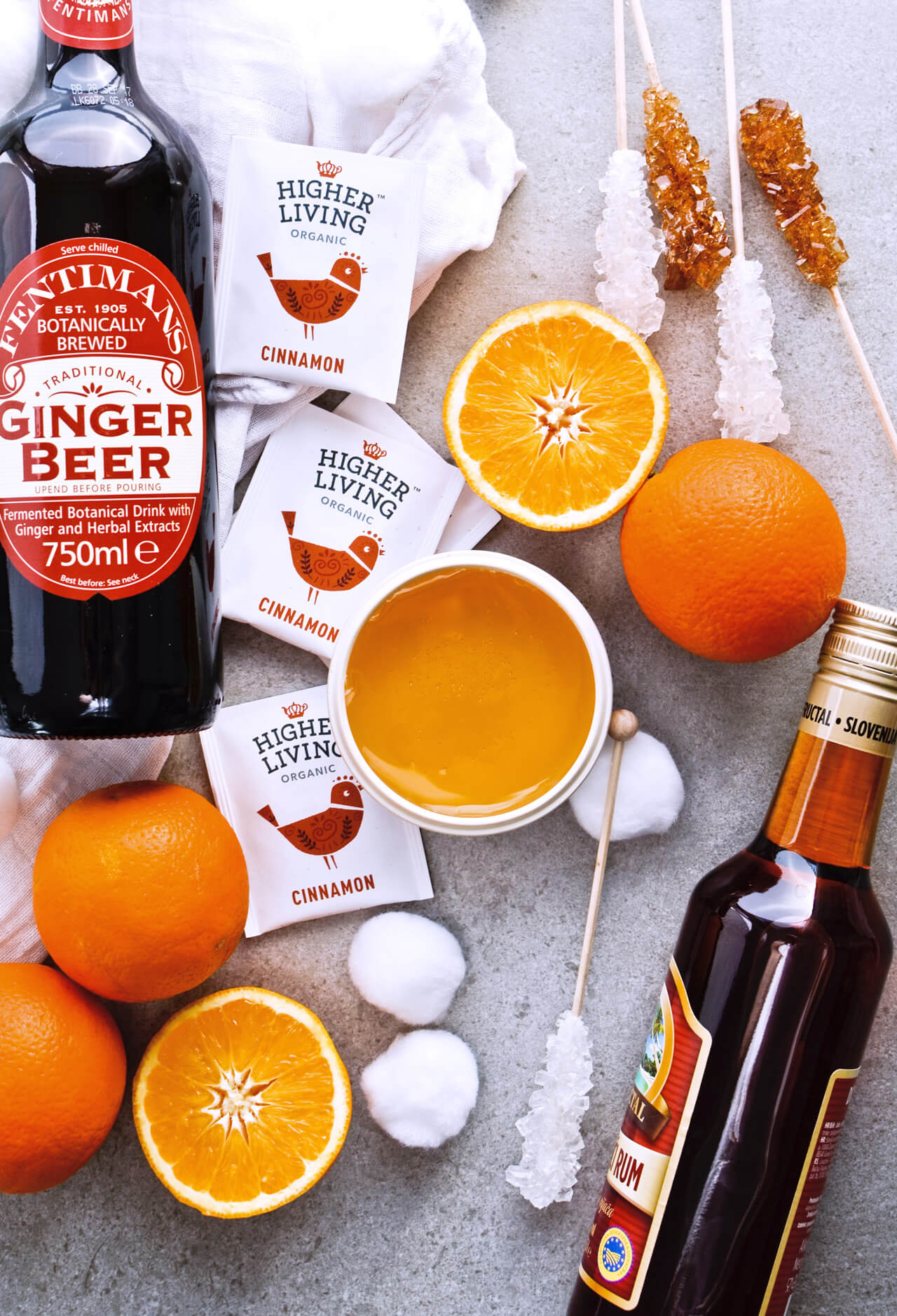 Recipe for Winter tea rum punch, the perfect winter cozy drink! Made with orange juice, honey, ginger beer and cinnamon baked apple teas! Served with orange twists and sugar swizzle sticks. A great cocktail made in 15 minutes! | @mitzyathome sugarsalted.com