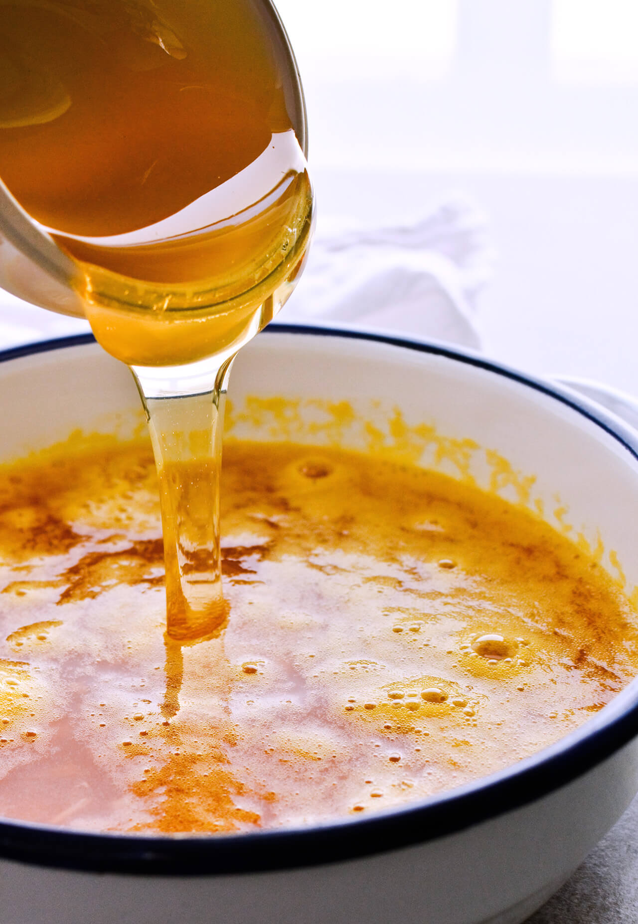 Recipe for Winter tea rum punch, the perfect winter cozy drink! Made with orange juice, honey, ginger beer and cinnamon baked apple teas! Served with orange twists and sugar swizzle sticks. A great cocktail made in 15 minutes! | @mitzyathome sugarsalted.com
