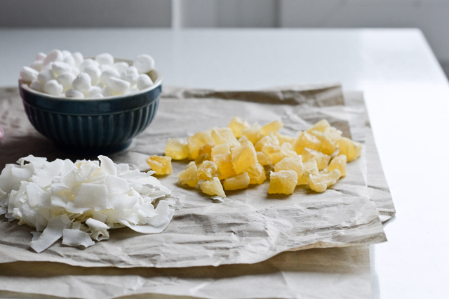 Tropical white chocolate bark with meringues, candied pineapple, coconut chips and sprinkles! Cute dessert or cake topper.
