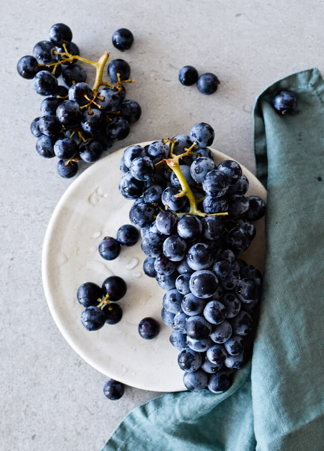 Concord grape syrup ginger beer floats will make you feel like a child again! Made with easy homemade syrup and lots of vanilla ice cream, these make the perfect early Fall - Autumn treat.