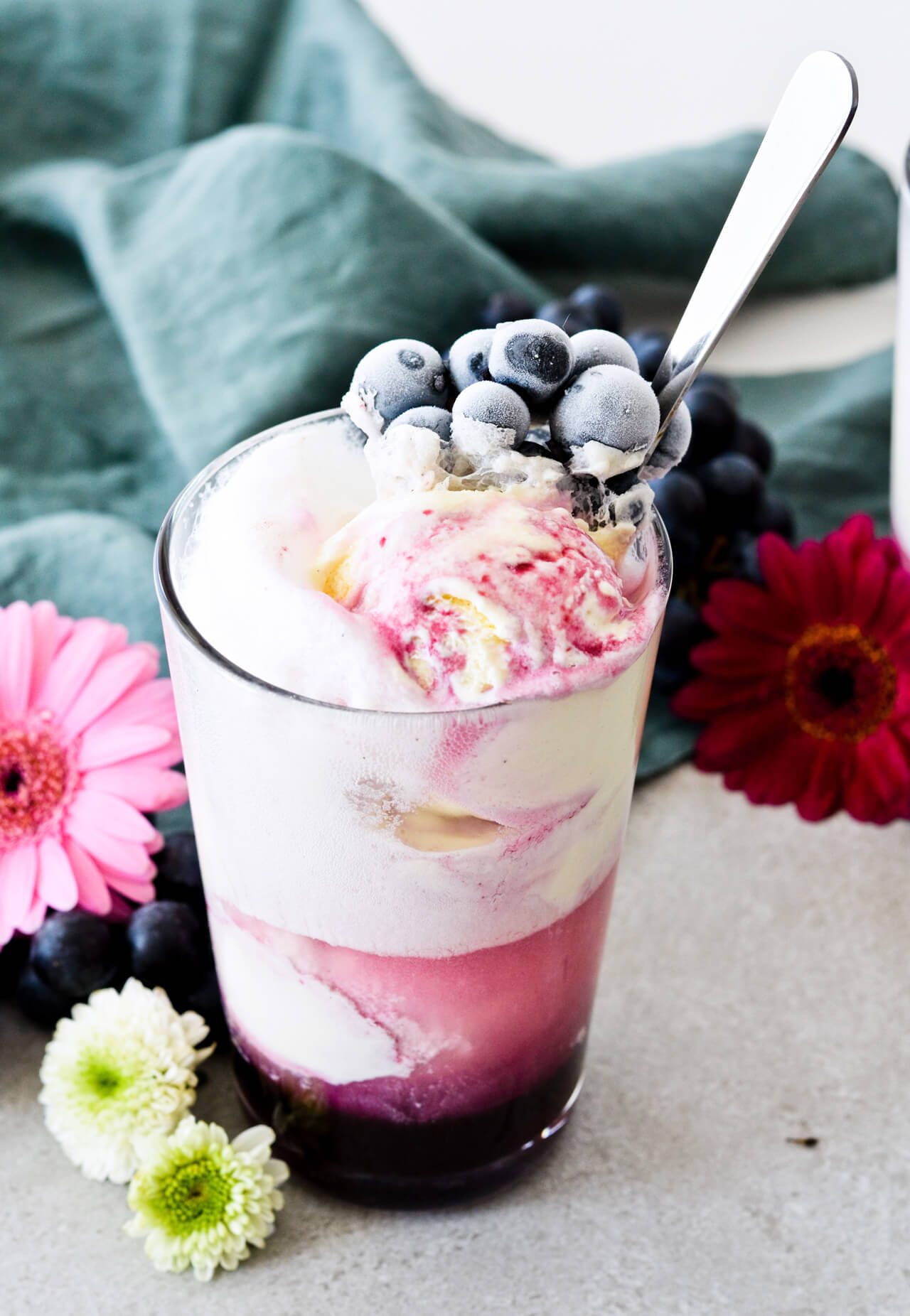 Concord grape syrup ginger beer floats will make you feel like a child again! Made with easy homemade syrup and lots of vanilla ice cream, these make the perfect early Fall - Autumn treat.