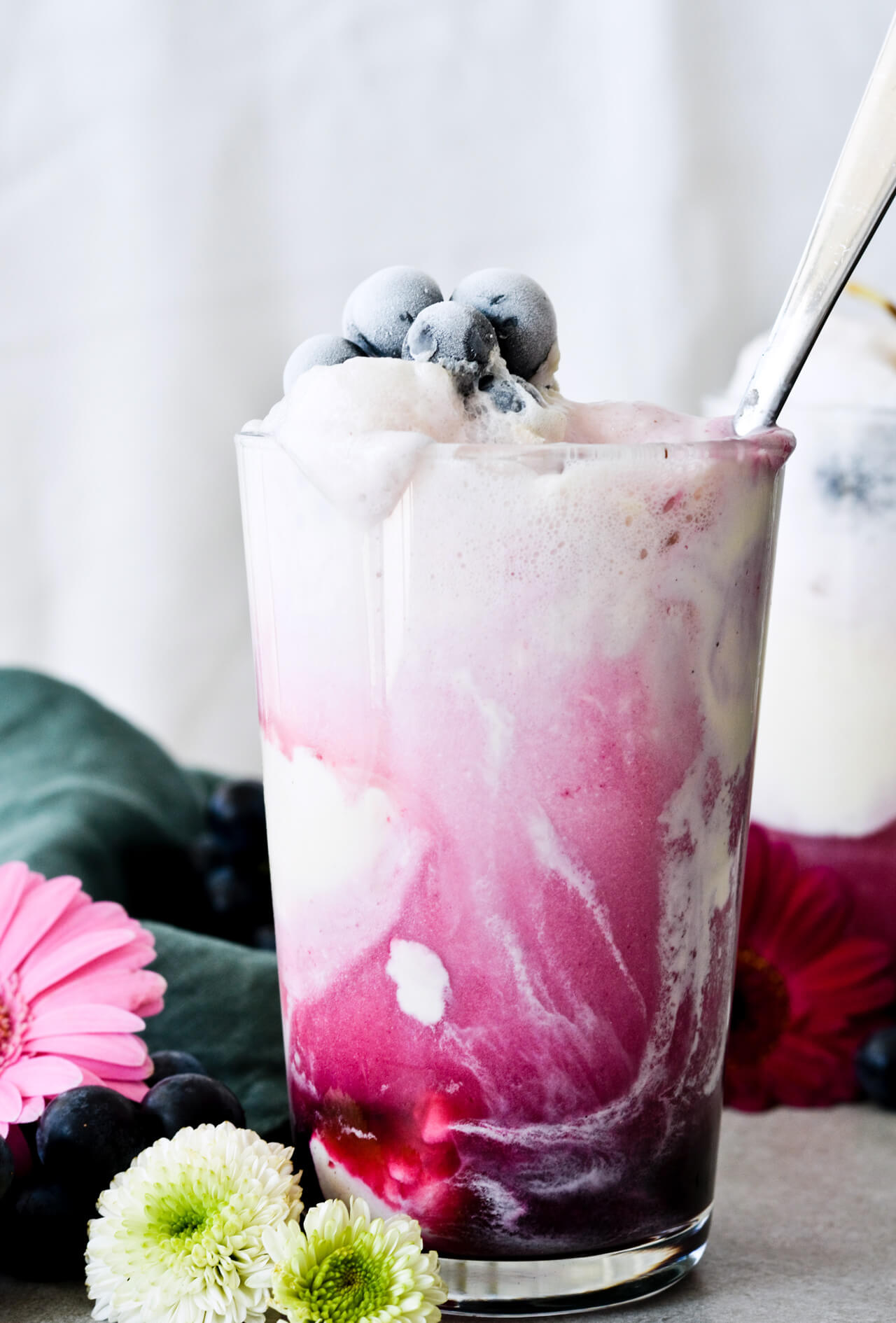 Concord grape syrup ginger beer floats will make you feel like a child again! Made with easy homemade syrup and lots of vanilla ice cream, these make the perfect early Fall - Autumn treat.