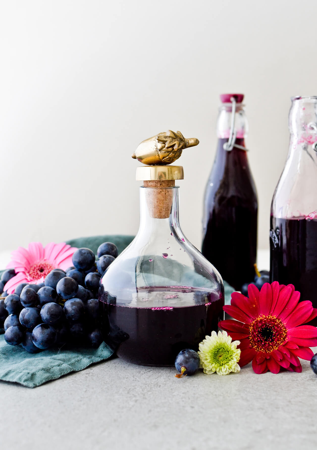 Concord grape syrup ginger beer floats will make you feel like a child again! Made with easy homemade syrup and lots of vanilla ice cream, these make the perfect early Fall - Autumn treat.