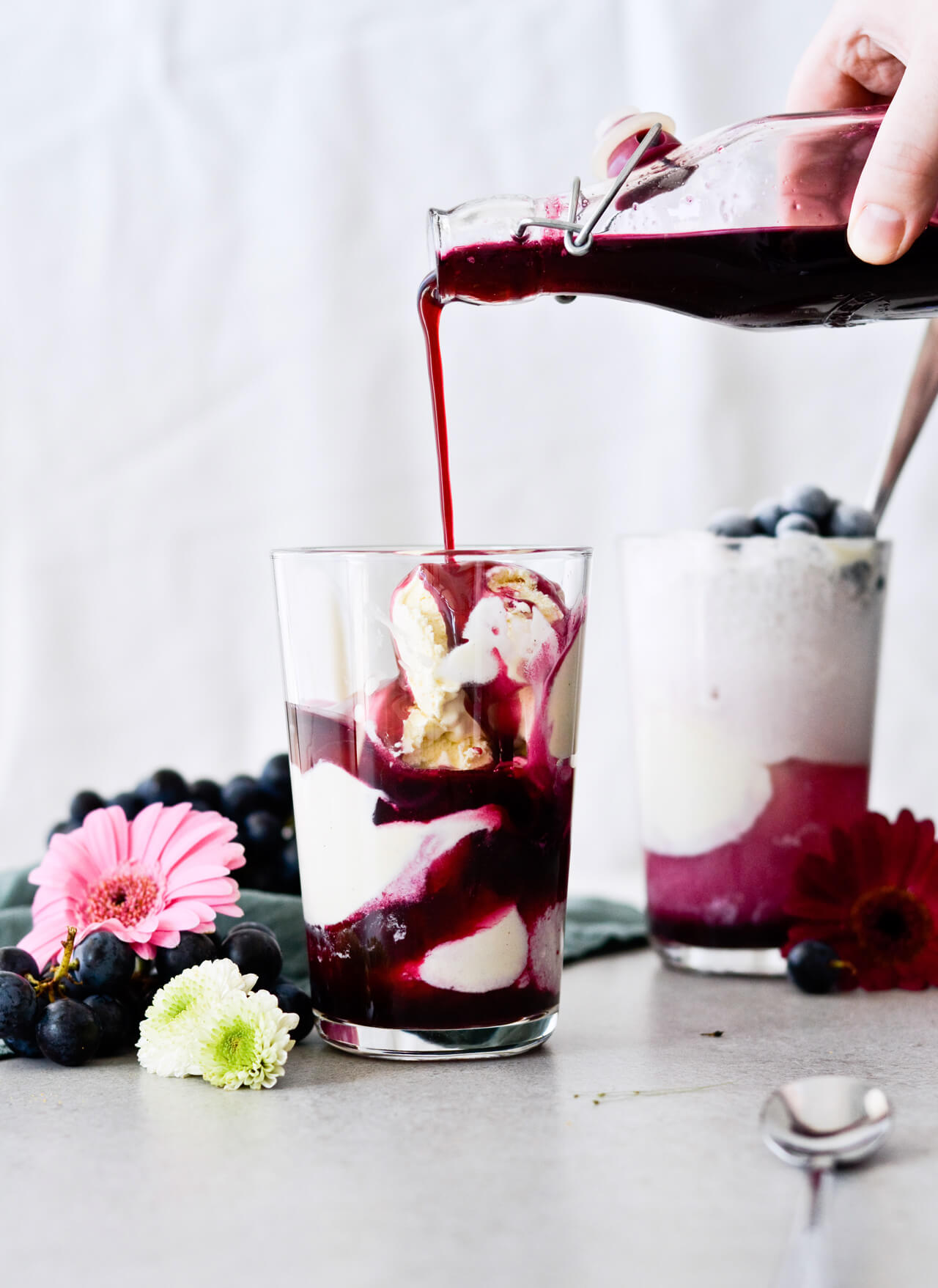 Concord grape syrup ginger beer floats will make you feel like a child again! Made with easy homemade syrup and lots of vanilla ice cream, these make the perfect early Fall - Autumn treat.