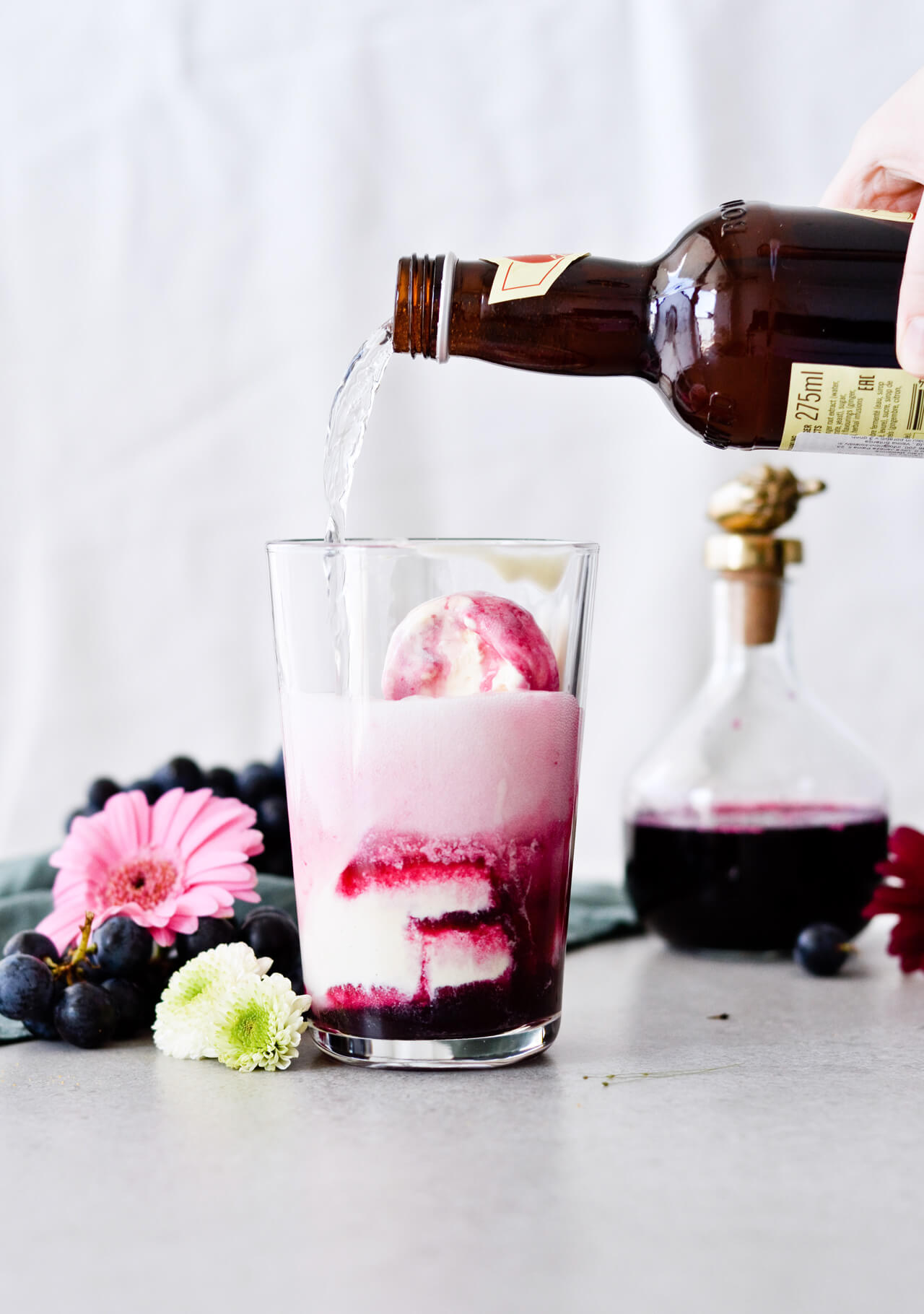 Concord grape syrup ginger beer floats will make you feel like a child again! Made with easy homemade syrup and lots of vanilla ice cream, these make the perfect early Fall - Autumn treat.