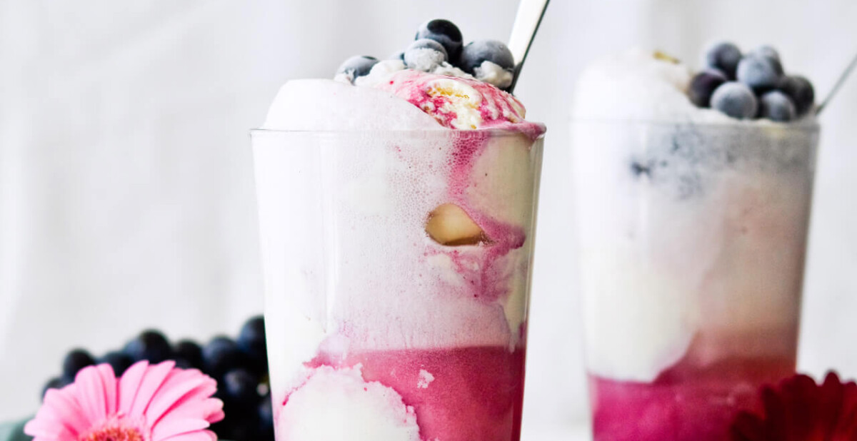 Concord grape syrup ginger beer floats will make you feel like a child again! Made with easy homemade syrup and lots of vanilla ice cream, these make the perfect early Fall - Autumn treat.