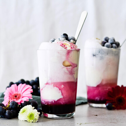 Concord grape syrup ginger beer floats will make you feel like a child again! Made with easy homemade syrup and lots of vanilla ice cream, these make the perfect early Fall - Autumn treat.