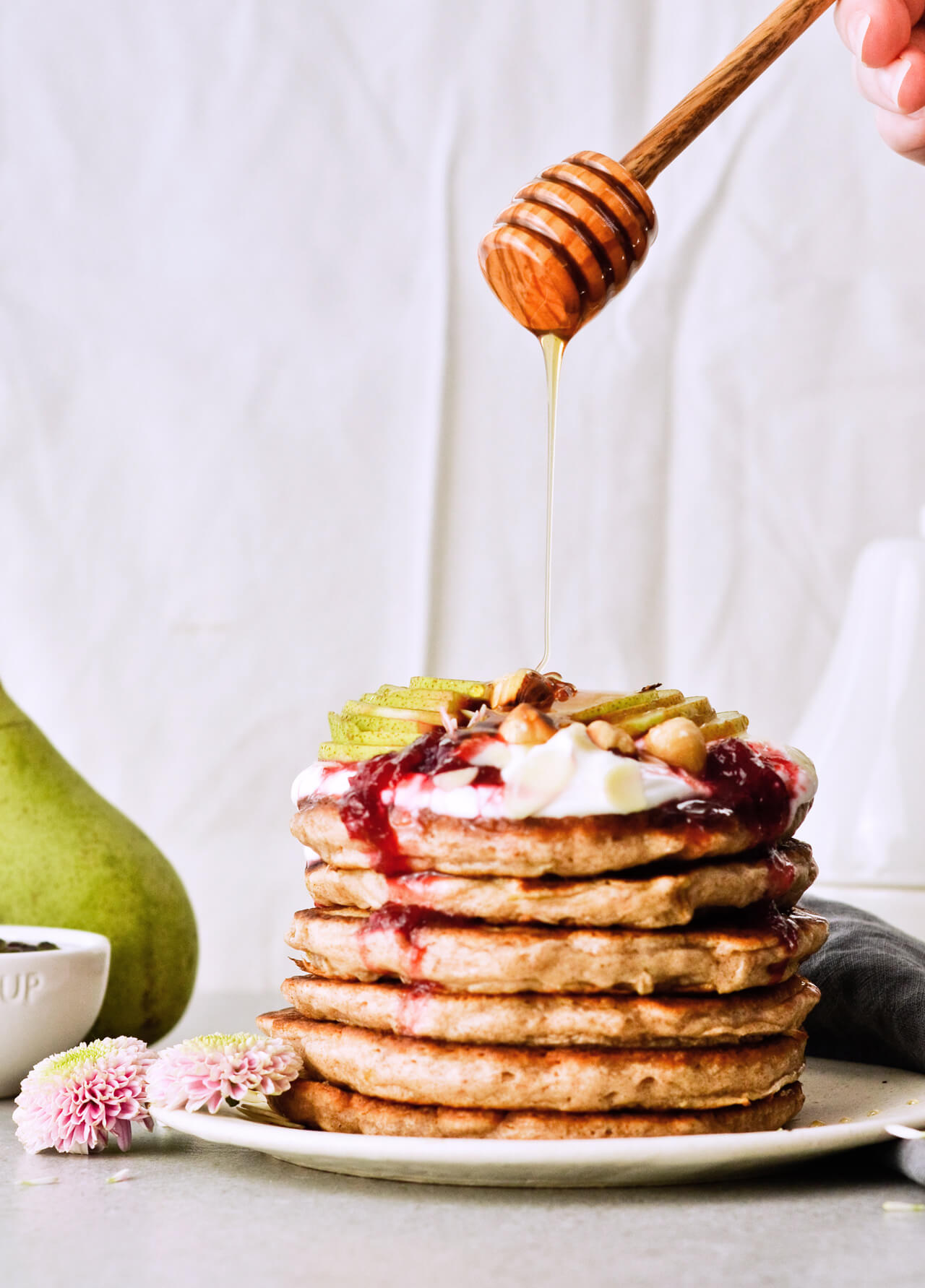 Recipe for shredded pear pancakes with yogurt and honey! Perfect Fall brunch recipe that makes fluffy, fruity pancakes everyone can enjoy. 