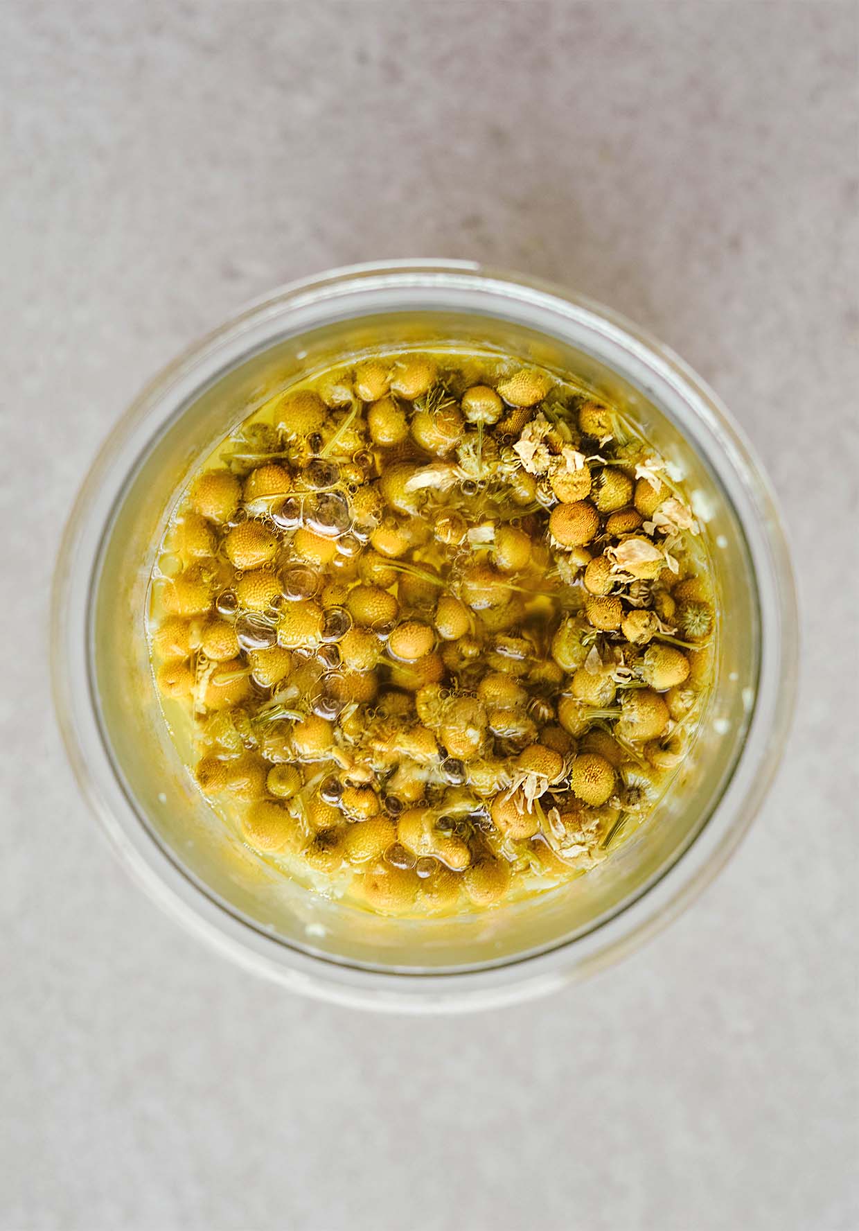 chamomile flowers soaked for tea in jar