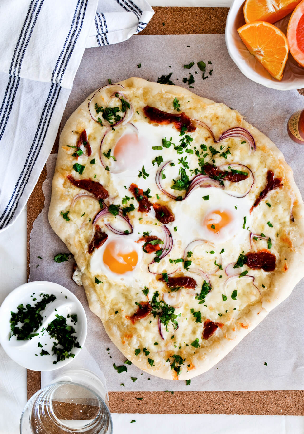 Easy vegetarian sun dried tomato onion breakfast pizza with eggs, easy brunch recipe that is quickly made.