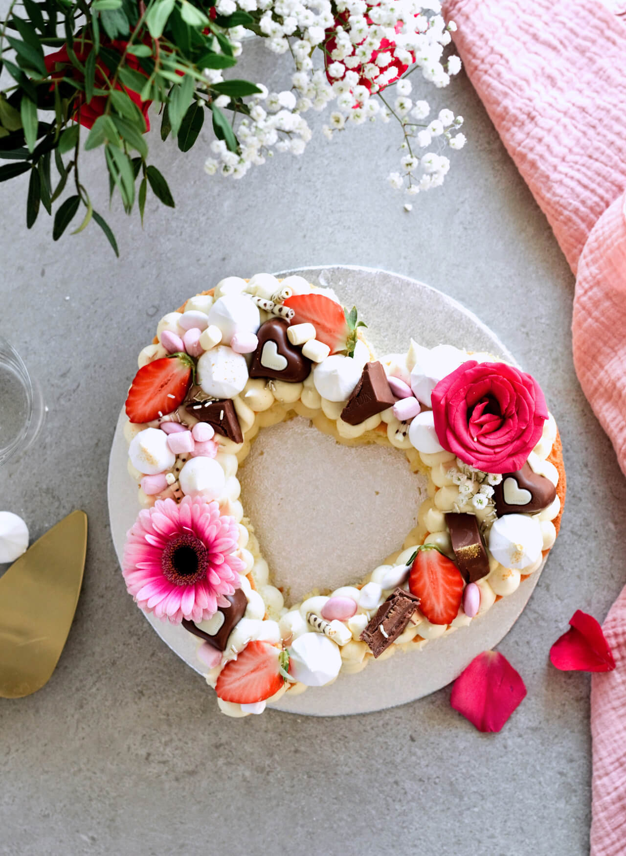White chocolate cream cheese naked heart cake is the perfect spring or summer cake, topped with fresh berries and flowers it's eye-catching and pretty.