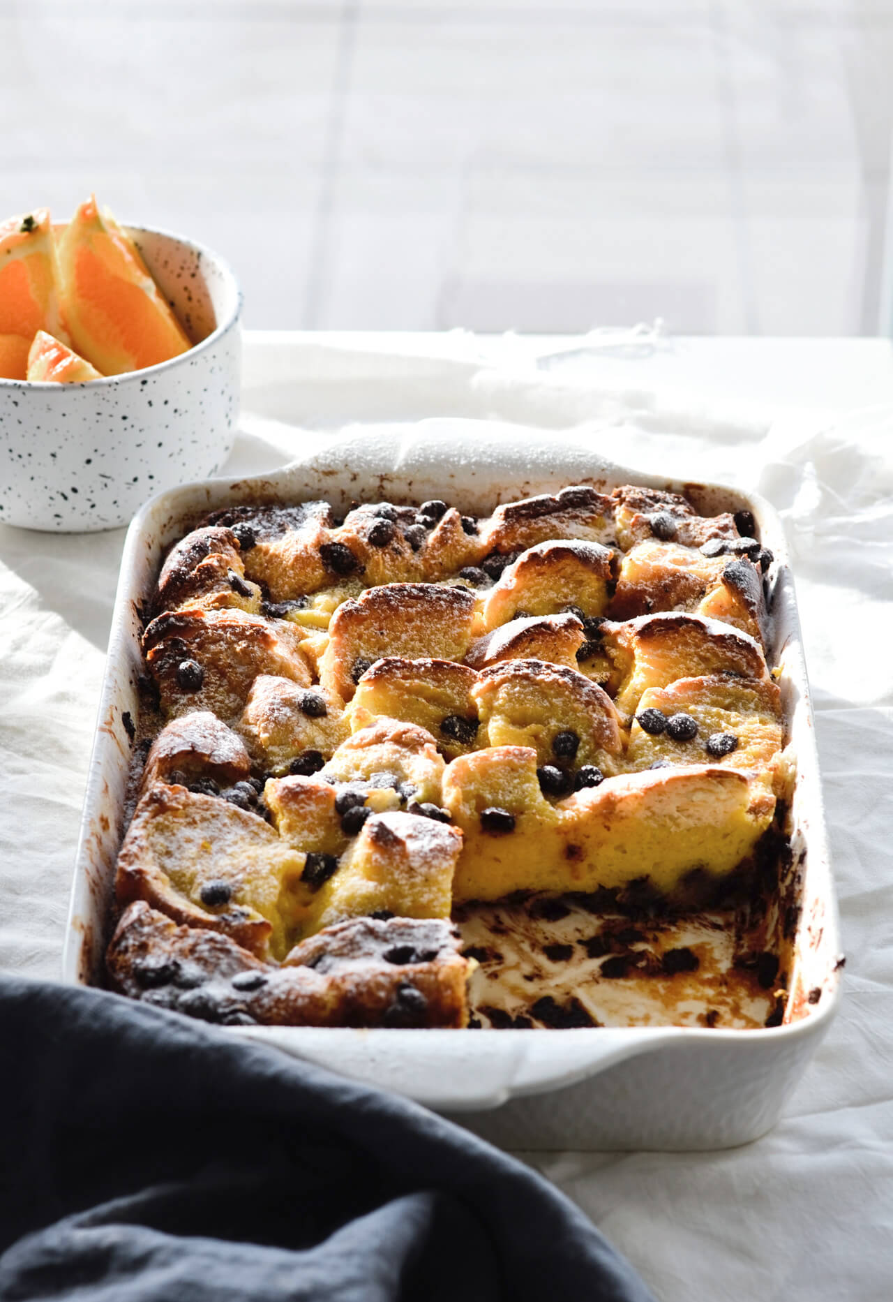 Easy to make orange chocolate chip bread pudding, made with challah and topped with whipped cream. Perfect brunch or dessert!