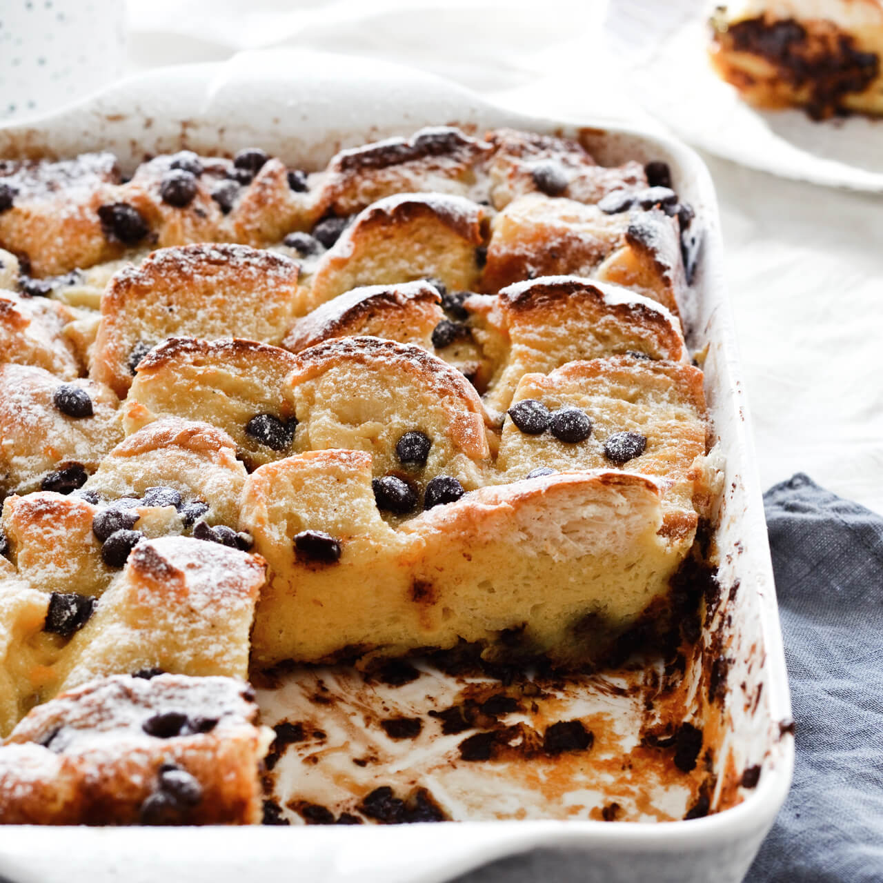 Easy to make orange chocolate chip bread pudding, made with challah and topped with whipped cream. Perfect brunch or dessert!