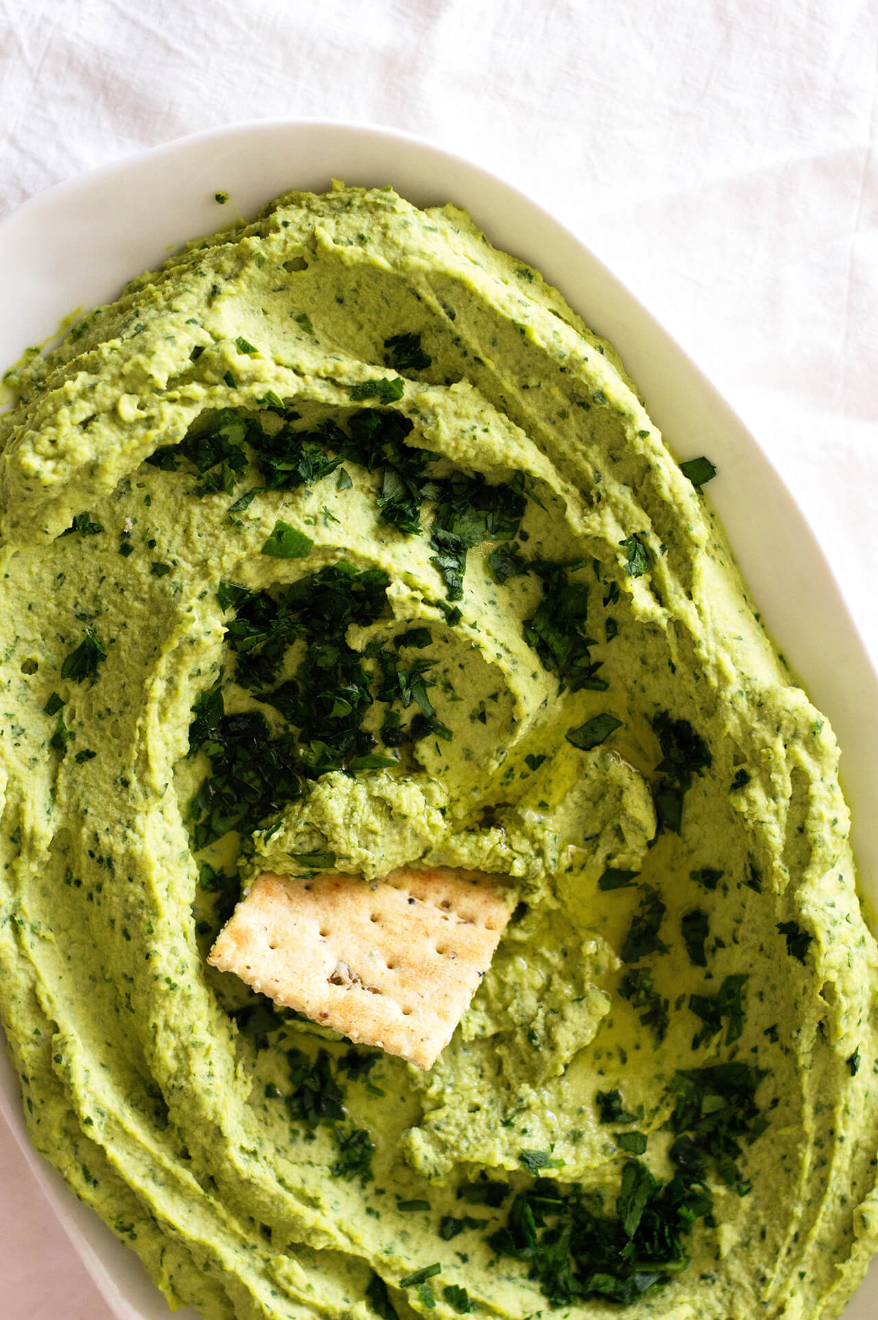 Recipe for simple parsley hummus, a fresh twist on a classic favorite, perfect dip for entertaining, spread for sandwiches or addition to dinner. 