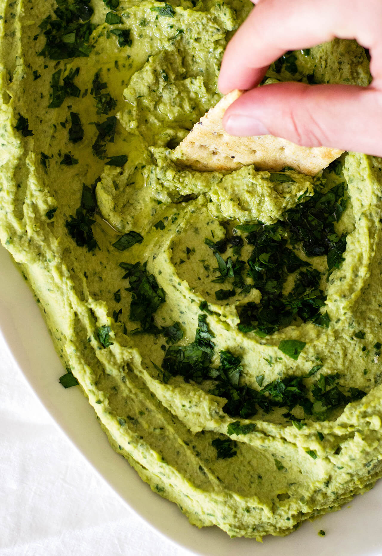 Recipe for simple parsley hummus, a fresh twist on a classic favorite, perfect dip for entertaining, spread for sandwiches or addition to dinner. 